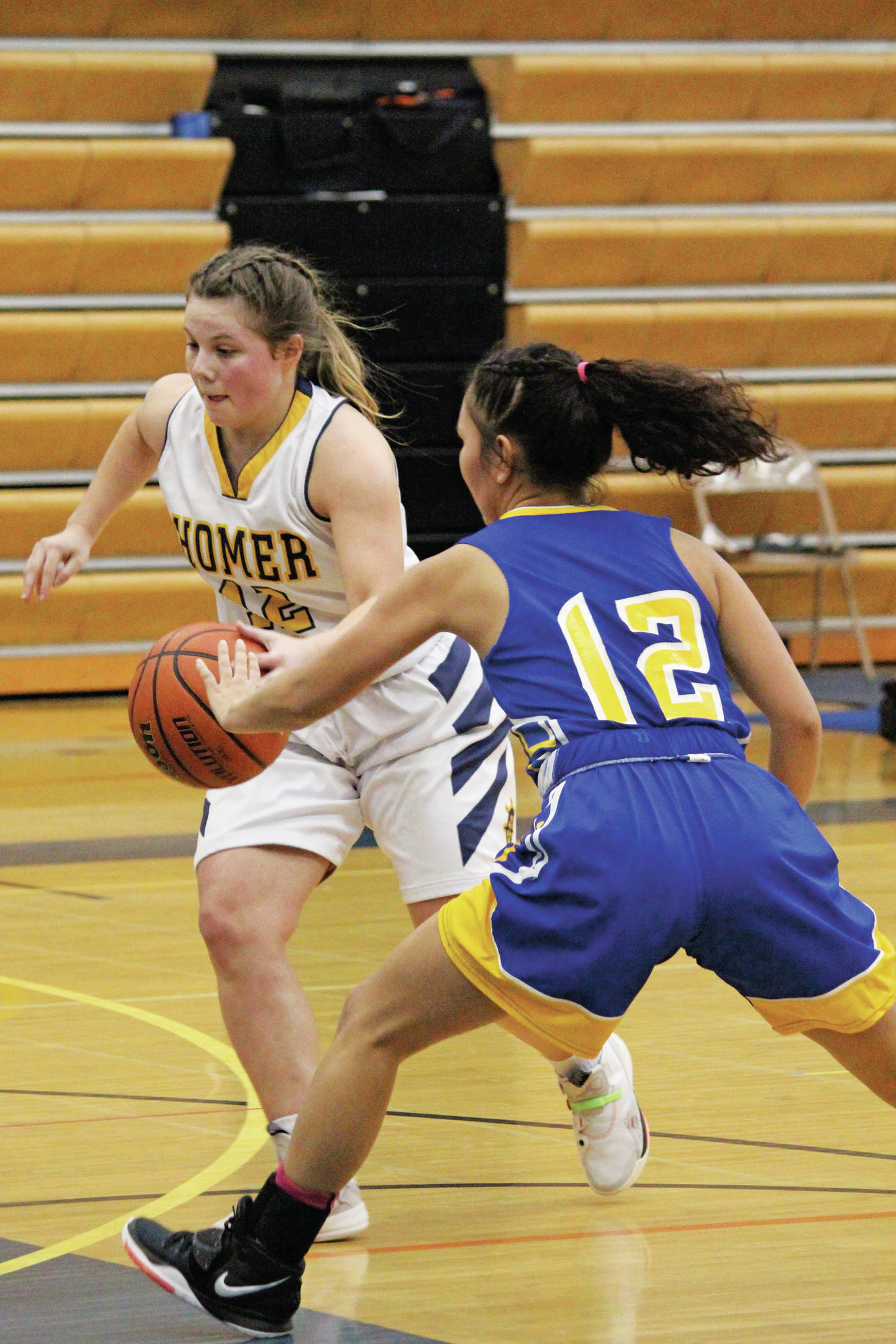 Galena’s Julia Heckman tries to knock the ball away from Homer’s Rylee Doughty during a Friday, Feb. 7, 2020 basketball game during the Homer Winter Carnival Basketball Tournament at Homer High School in Homer, Alaska. (Photo by Megan Pacer/Homer News)