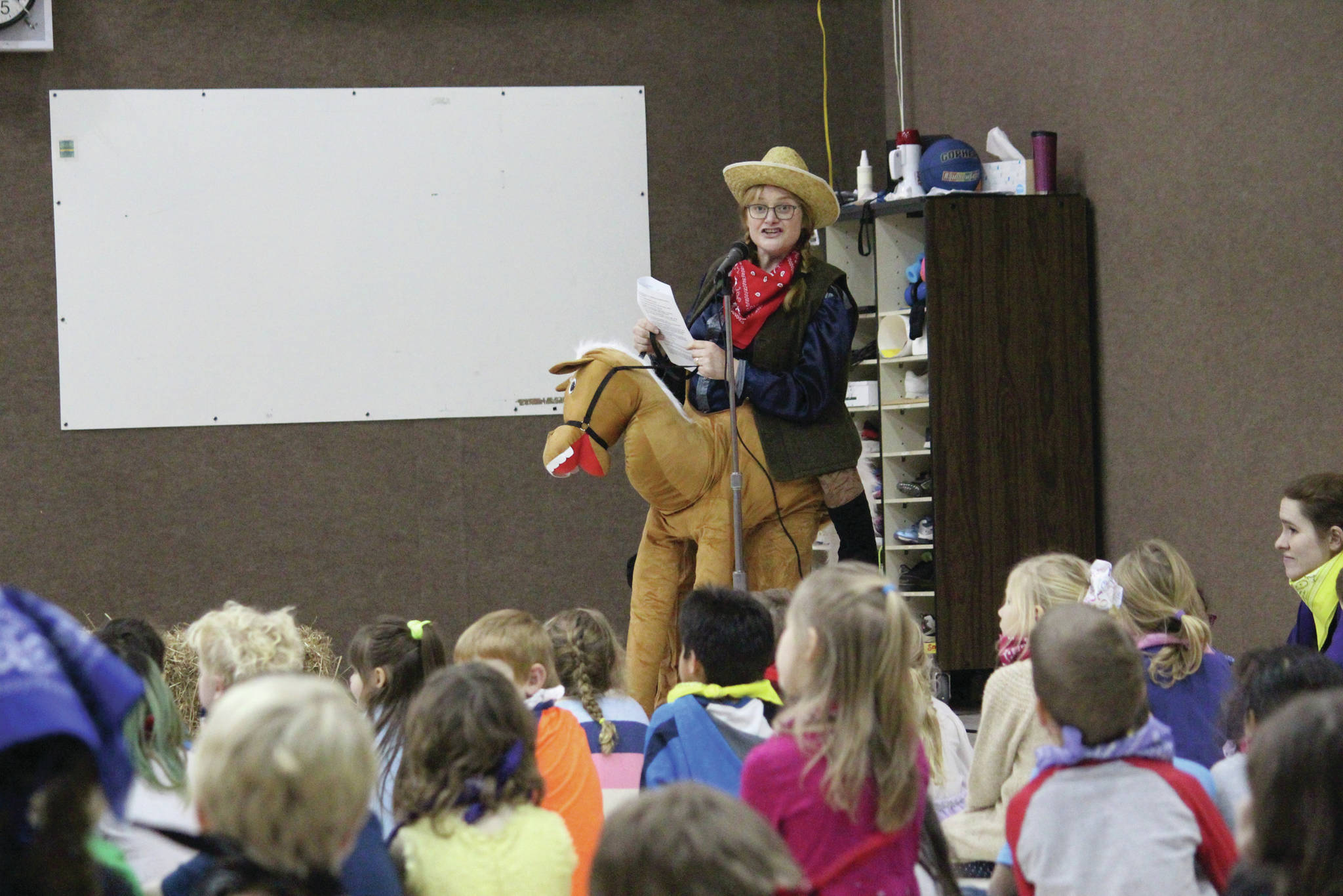 Mindy Hunter performs part of a staff skit for Paul Banks Elementary School students during an assembly to celebrate the start of the school’s annual read-a-thon Feb. 3, 2020 at the school in Homer, Alaska. (Photo by Megan Pacer/Homer News)