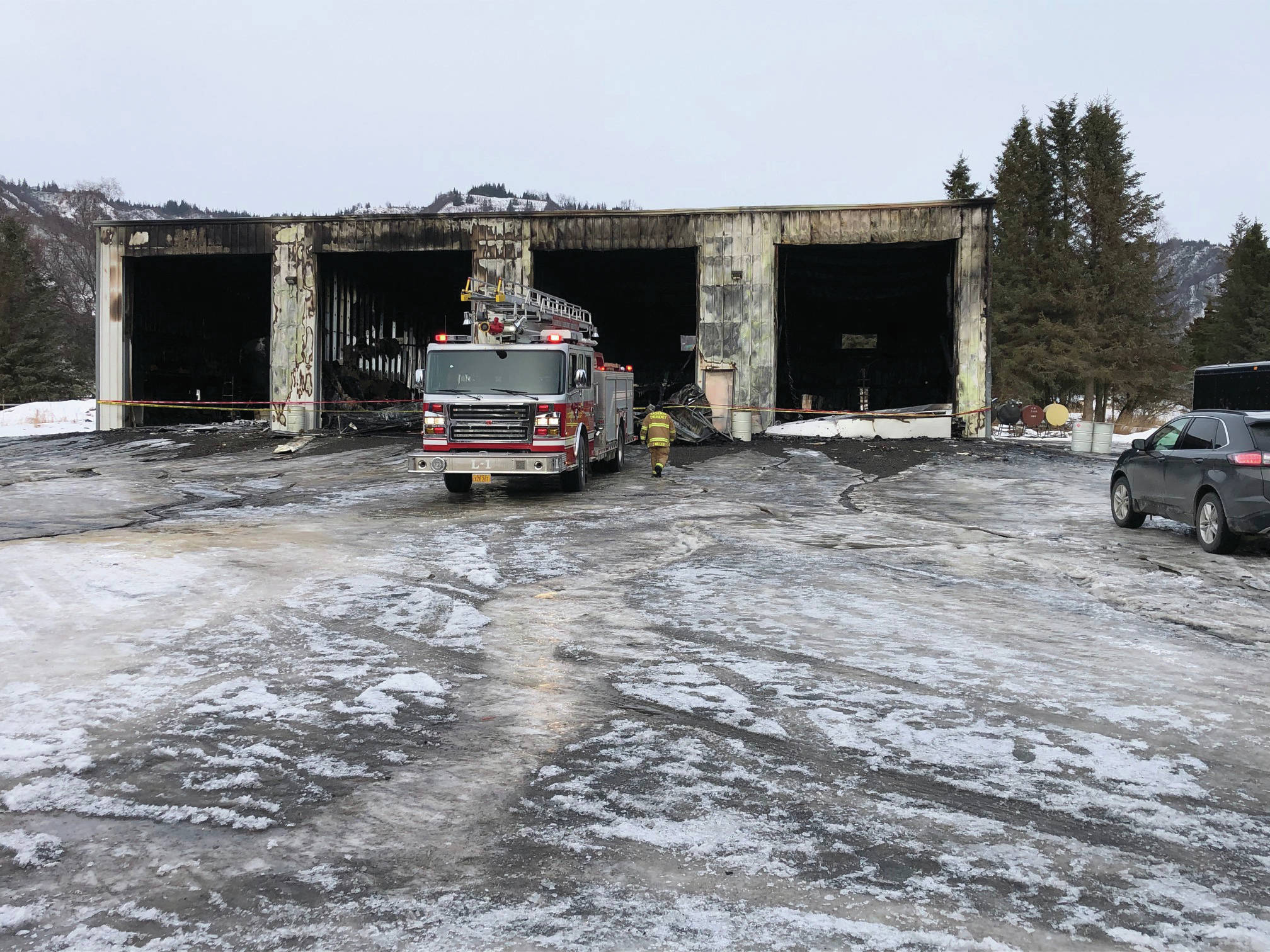 Kachemak Emergency Services firefighters on Friday afternoon, Feb. 14, 2020, clean up a structure fire on Kent Street near Mile 6.5 East End Road east of Homer, Alaska. A fire in a boat shop that started about 3:25 a.m. Feb. 14 totally destroyed the building. (Photo courtesy Kachemak Emergency Services)