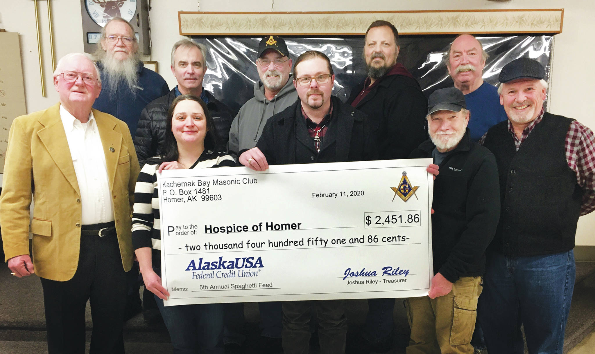 Members of the Kachemak Bay Masonic Club, in cooperation with Homer Elks #2127, held its 5th Annual Masonic Awareness Spaghetti Feed Fundraiser on Jan. 25, 2020, at the Homer Elks Lodge to benefit Hospice of Homer in Homer, Alaska. Proceeds to Hospice totaled $2,451.86. Masons pose here with a celebratory check presented to Hospice of Homer officials. They are, front row, right to left: Doug Baily, Hospice of Homer Executive Director Jessica Golden, Joshua Riley, Hospice of Homer Board member Michael Hawfield, and Tom Stroozas; back row, from left to right, Grady Svoboda, Dave Rush, Barry Haynes, Greg Martin and Jody Murdock. (Photo courtesy of Kachemak Bay Masonic Club)