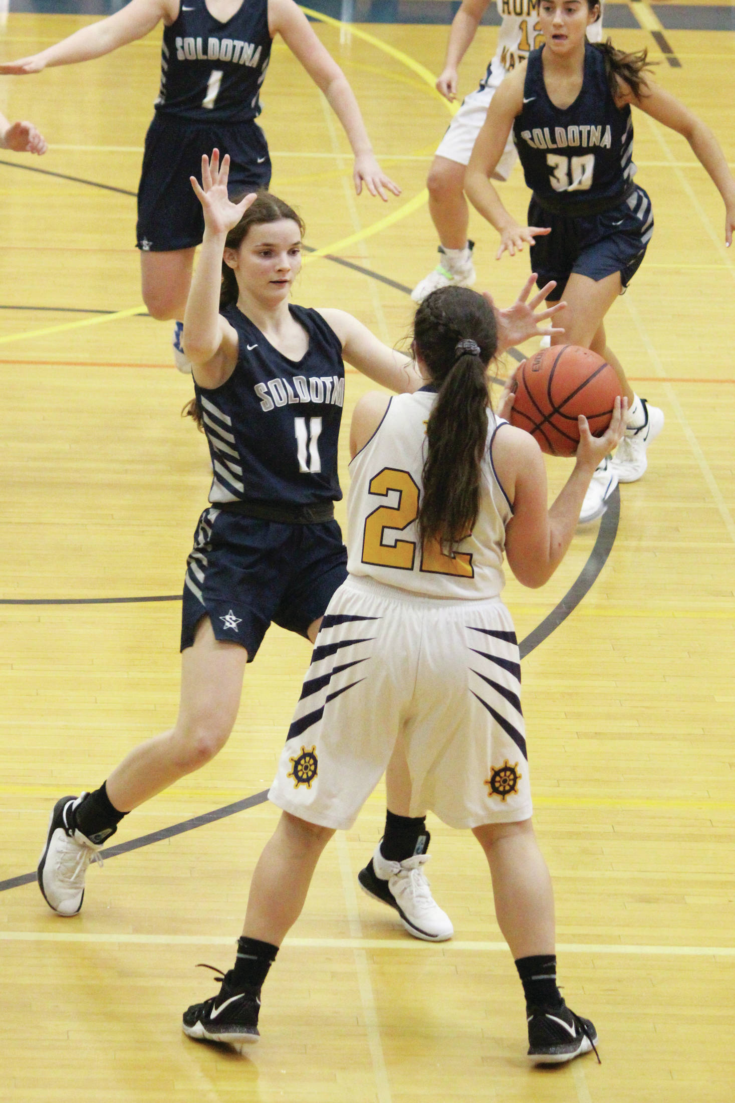 Soldotna’s Morgan Bouschor guards Homer’s Hannah Hatfield during a Tuesday, Feb. 25, 2020 basketball game in the Alice Witte Gymnasium in Homer, Alaska. (Photo by Megan Pacer/Homer News)
