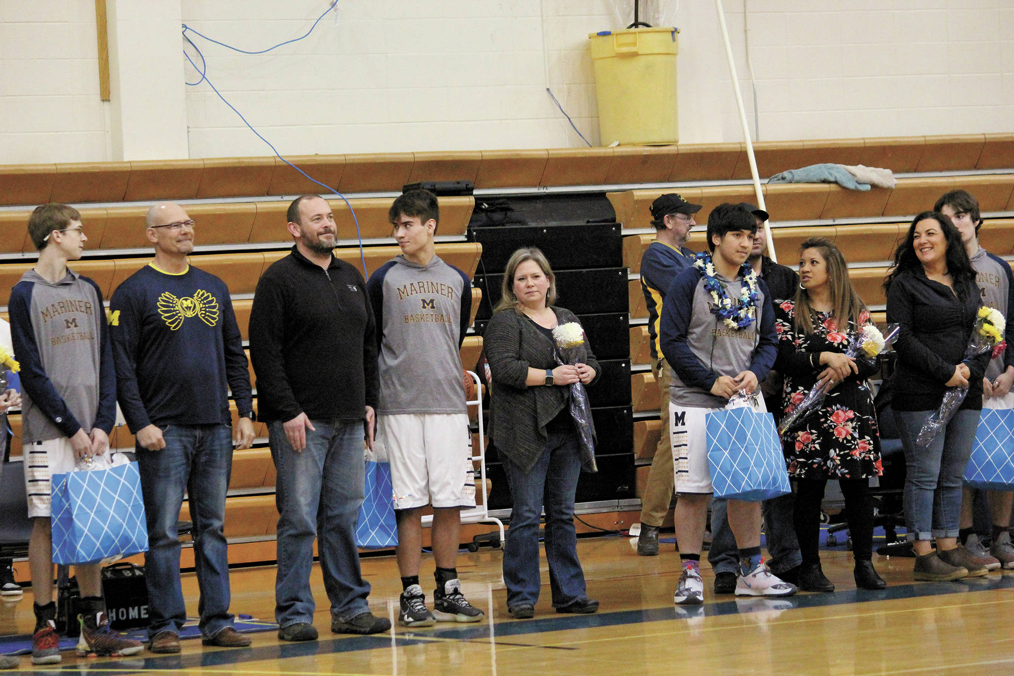 Senior members of the Homer boys varsity basketball team are honored on senior night before a Friday, Feb. 28, 2020 game against Nikiski in the Alice Witte Gymnasium in Homer, Alaska. (Photo by Megan Pacer/Homer News)