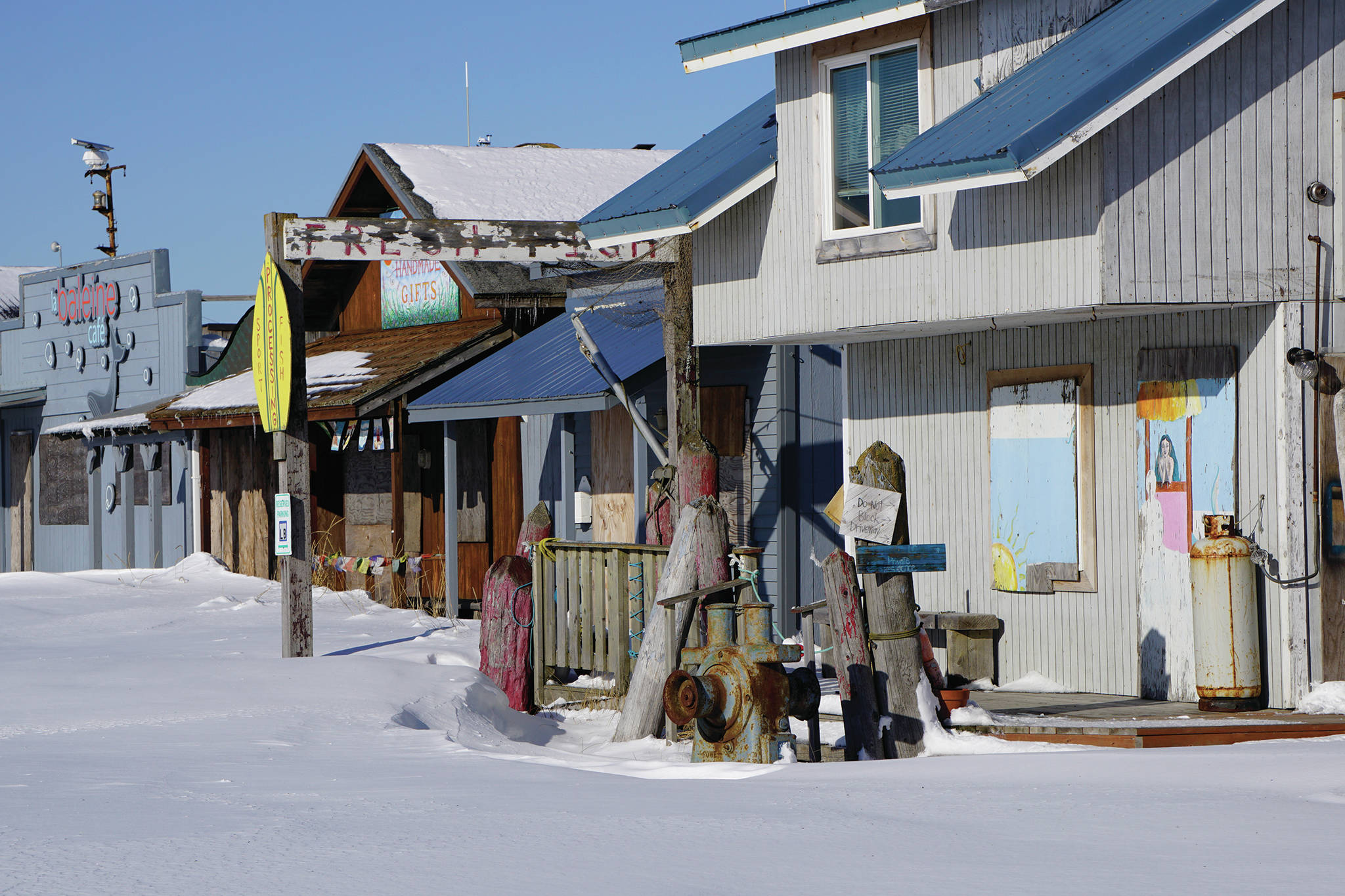 Snow drifts cover the parking lot of boarded-up cafes and shops on the Homer Spit on Feb, 24, 2020, in Homer, Alaska. Except for the Salty Dawg, Coal Point Seafoods and Land’s End Resort, most of the Spit is closed for the season. (Photo by Michael Armstrong/Homer News)