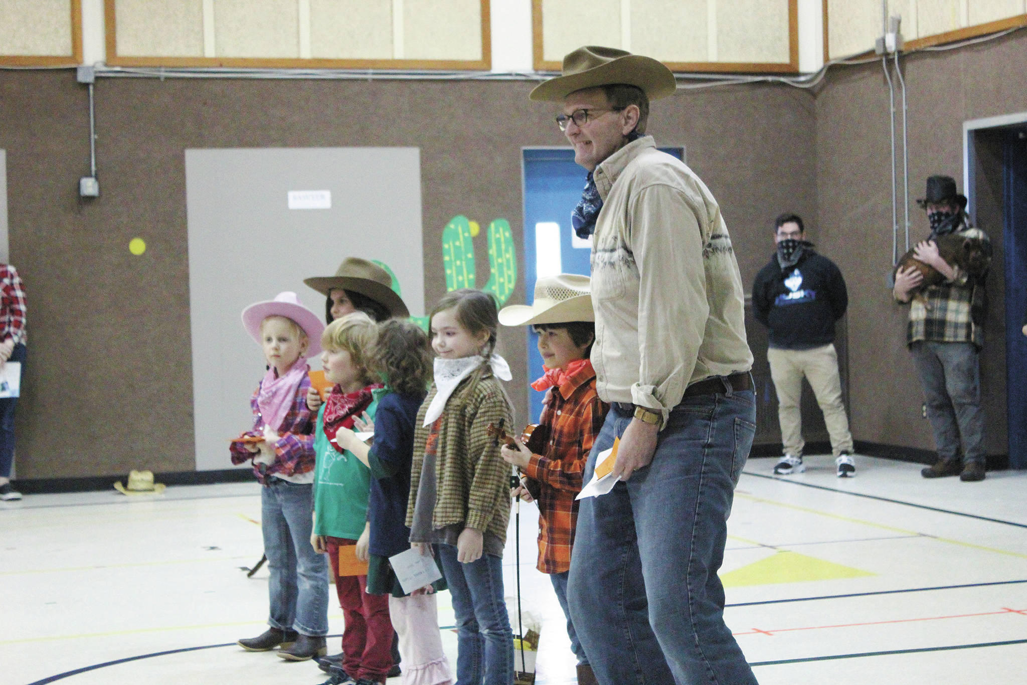 Paul Banks Elementary School Principal Eric Pedersen celebrates with the students who read the most minutes and raised the most money during the school’s annual read-a-thon, at a Thursday, March 5, 2020 assembly at the school in Homer, Alaska. (Photo by Megan Pacer/Homer News)
