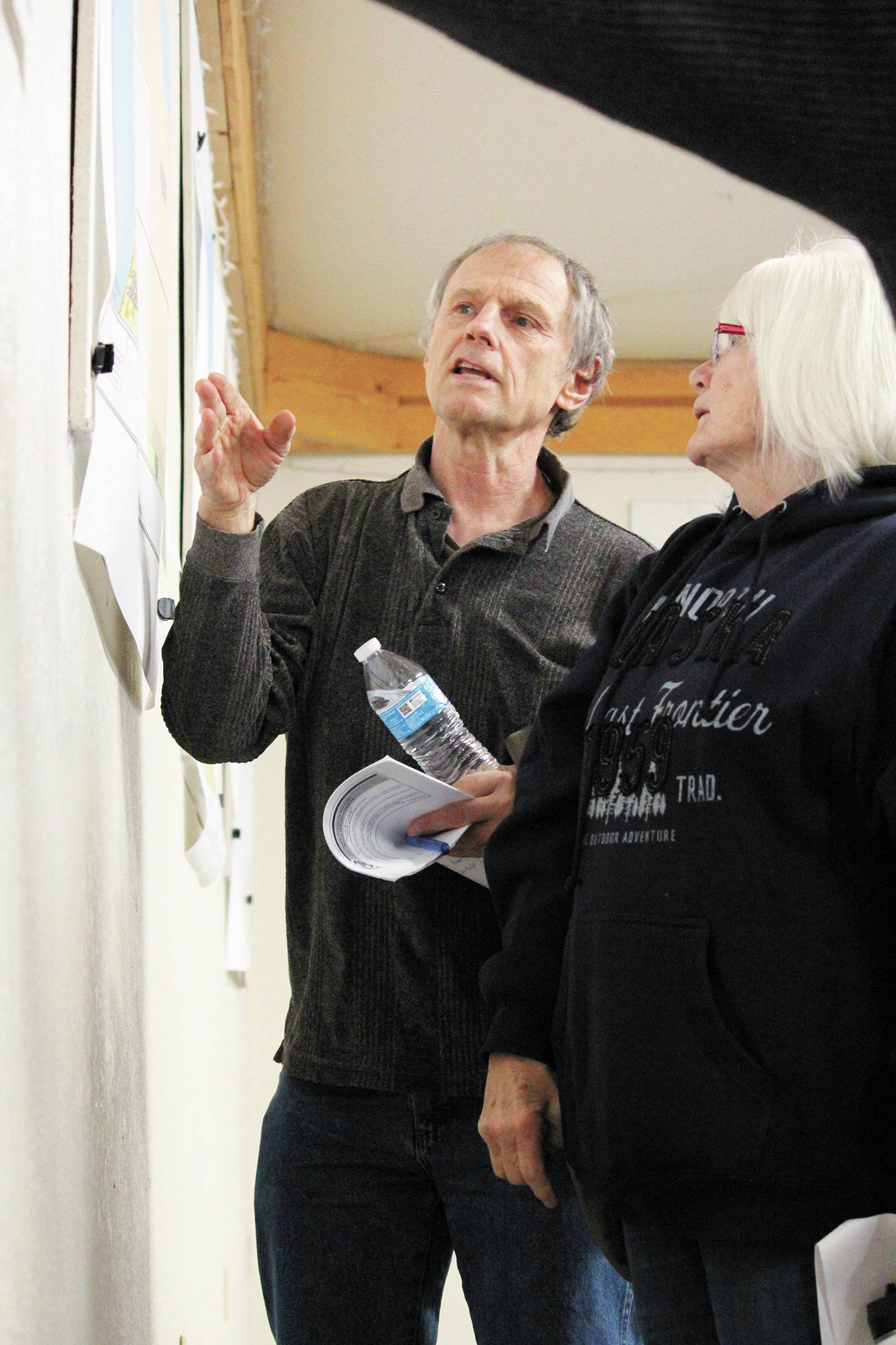 Kenai Peninsula Borough Assembly member Brent Johnson speaks with Ninilchik community member Nancy DePodesta about the proposed boundaries for a potential fire and EMS service area for the area at a borough public hearing held Monday, March 9, 2020 at the Kenai Peninsula Fairgrounds in Ninilchik, Alaska. (Photo by Megan Pacer/Homer News)