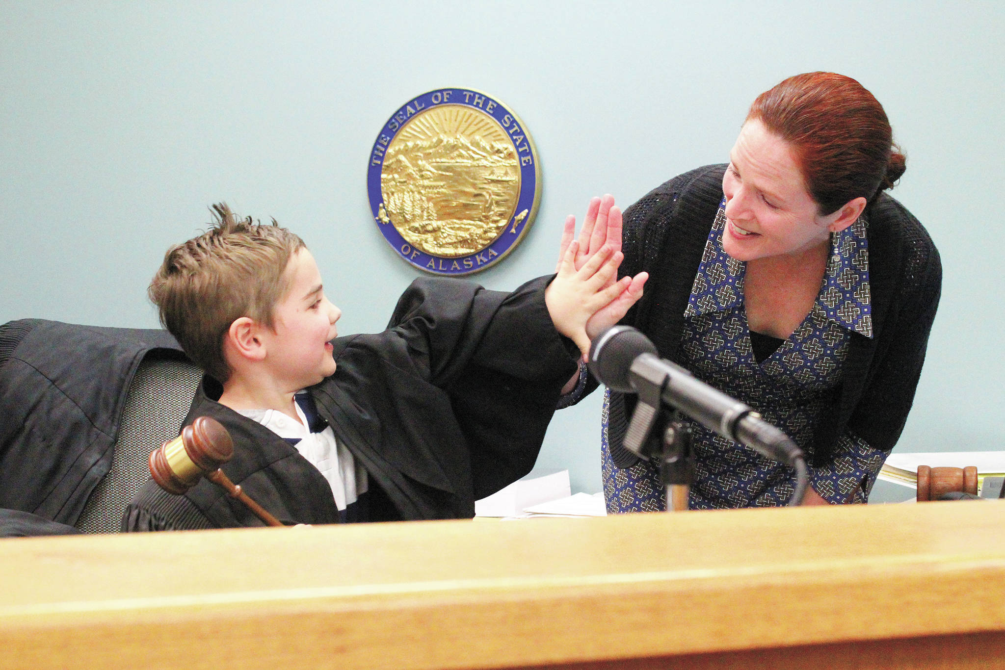 Bride Seifert, Homer’s first Superior Court judge, high fives 5-year-old Atticus Torres after he called for order in the courtroom during an an open house for the community Thursday, March 5, 2020 at the Homer Court in Homer, Alaska. (Photo by Megan Pacer/Homer News)