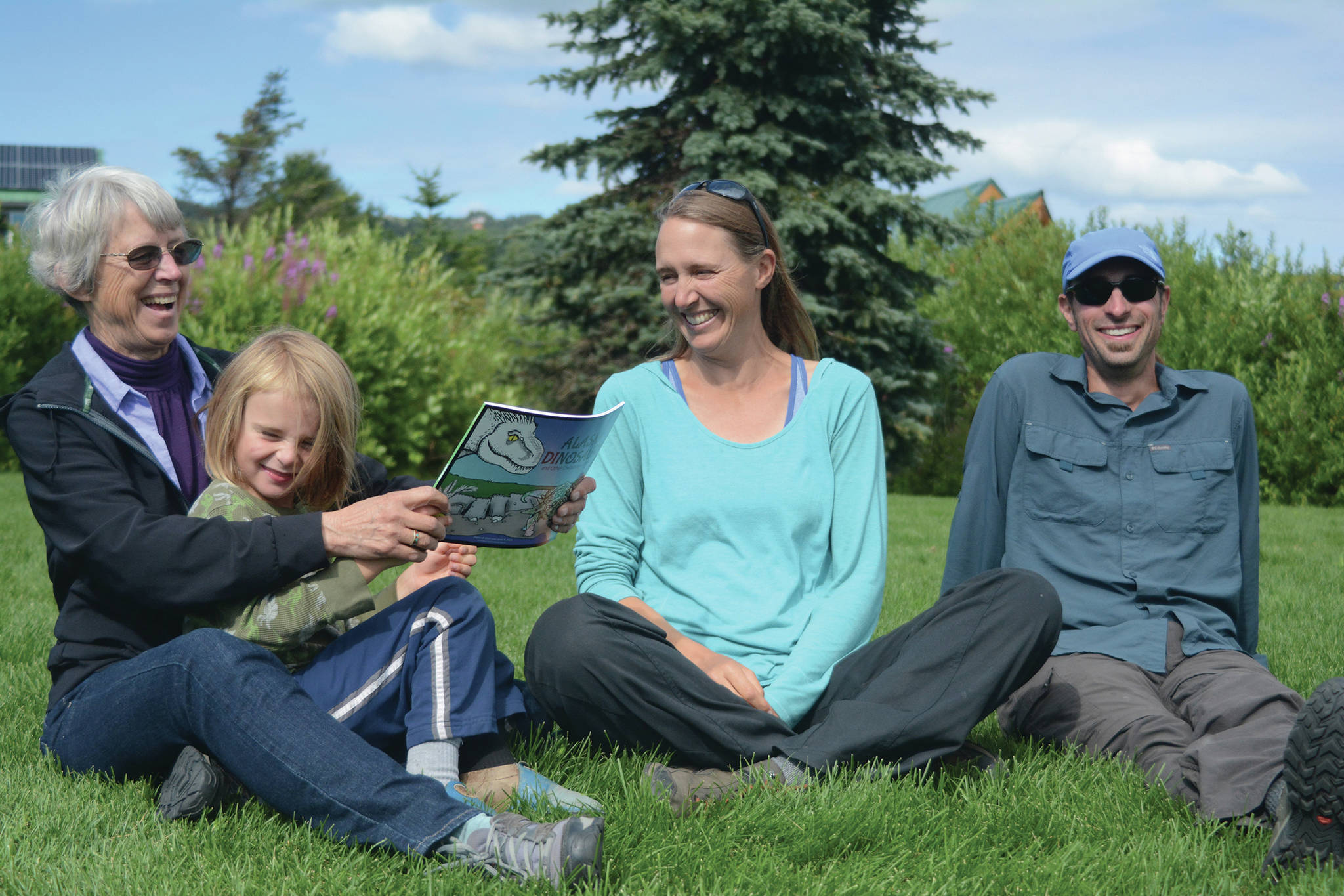 Janet R. Klein, left, holds her grandson, Sylas Reising, 4, while she visits with her daughter, Deborah Klein, center, and son-in-law George Reising, right, at Bishop’s Beach, Homer, Alaska, on Aug. 9, 2018. Janet Klein will receive the Lifelong Learner award in a ceremony on March 21, 2020, at the Homer Public Library. The Kleins wrote a “color and learn” book, “Alaska’s Dinosaurs and Other Cretaceous Creatures.” Sylas and Kai Reising, 6 (not shown) Sylas and Kai were the inspiration for the Kleins’ book. (Photo by Michael Armstrong/Homer News)