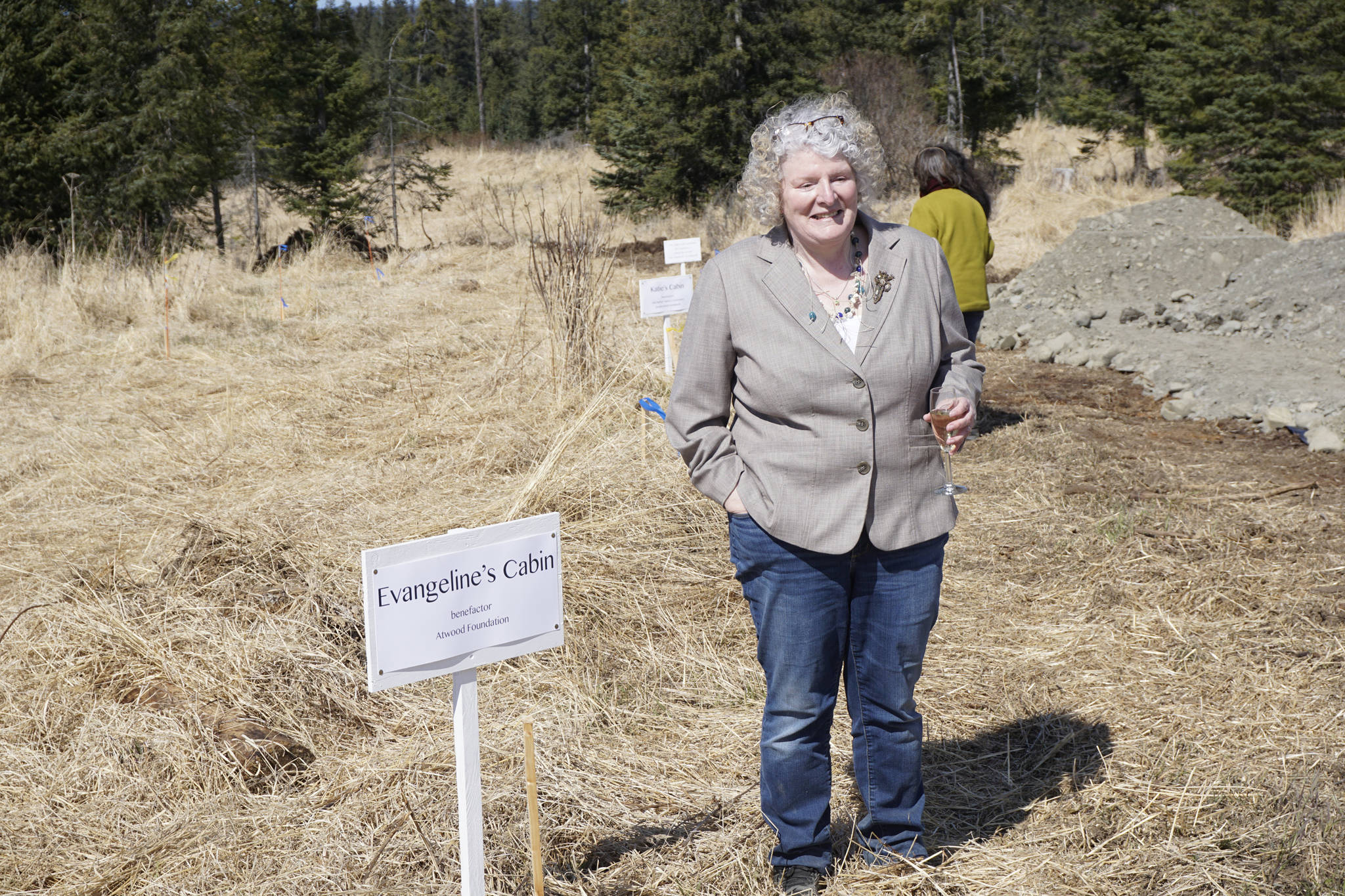 Homer writer and Storyknife Writers Retreat founder Dana Stabenow stands near the site of a cabin at groundbreaking ceremonies on May 4, 2019, at the retreat property in Homer, Alaska. Stabenow will receive the Susan Gibson Community Achievement Award for her work in founding Storyknife, a retreat for women writers. Construction started last year on the main house and cabins that will house visiting women writers. (Photo by Michael Armstrong/Homer News)