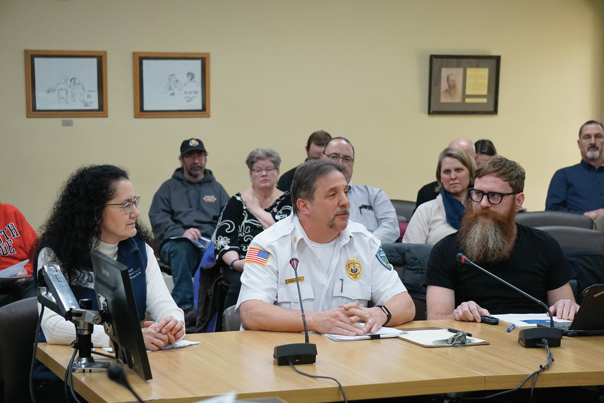 Homer Volunteer Fire Department Chief Mark Kirko, center, speaks to the Homer City Council about the novel coronavirus outbreak at its regular meeting on Monday, March 9, 2020, in Homer City Hall in Homer, Alaska. Also joining the presentation were South Peninsula Hospital spokesperson Derotha Ferraro, left, and Alaska Public Health nurse Lorne Carroll, right, team leader for the Homer Public Health office. (Photo by Michael Armstrong/Homer News)