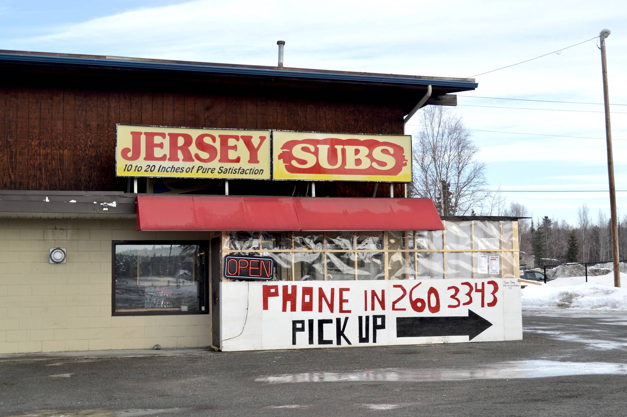 A sign advertising pickup orders can be seen at Kenai sandwich Jersey Subs on Thursday, March 26, 2020. Under new state mandates aiming to prevent the spread of the coronavirus local eateries can only provide takeout services. Under legislation recently passed by the U.S. Senate, small businesses with fewer than 500 employees that have federally guaranteed loans and who keep up their payroll also can get up to eight weeks of payments. (Victoria Petersen/Peninsula Clarion)