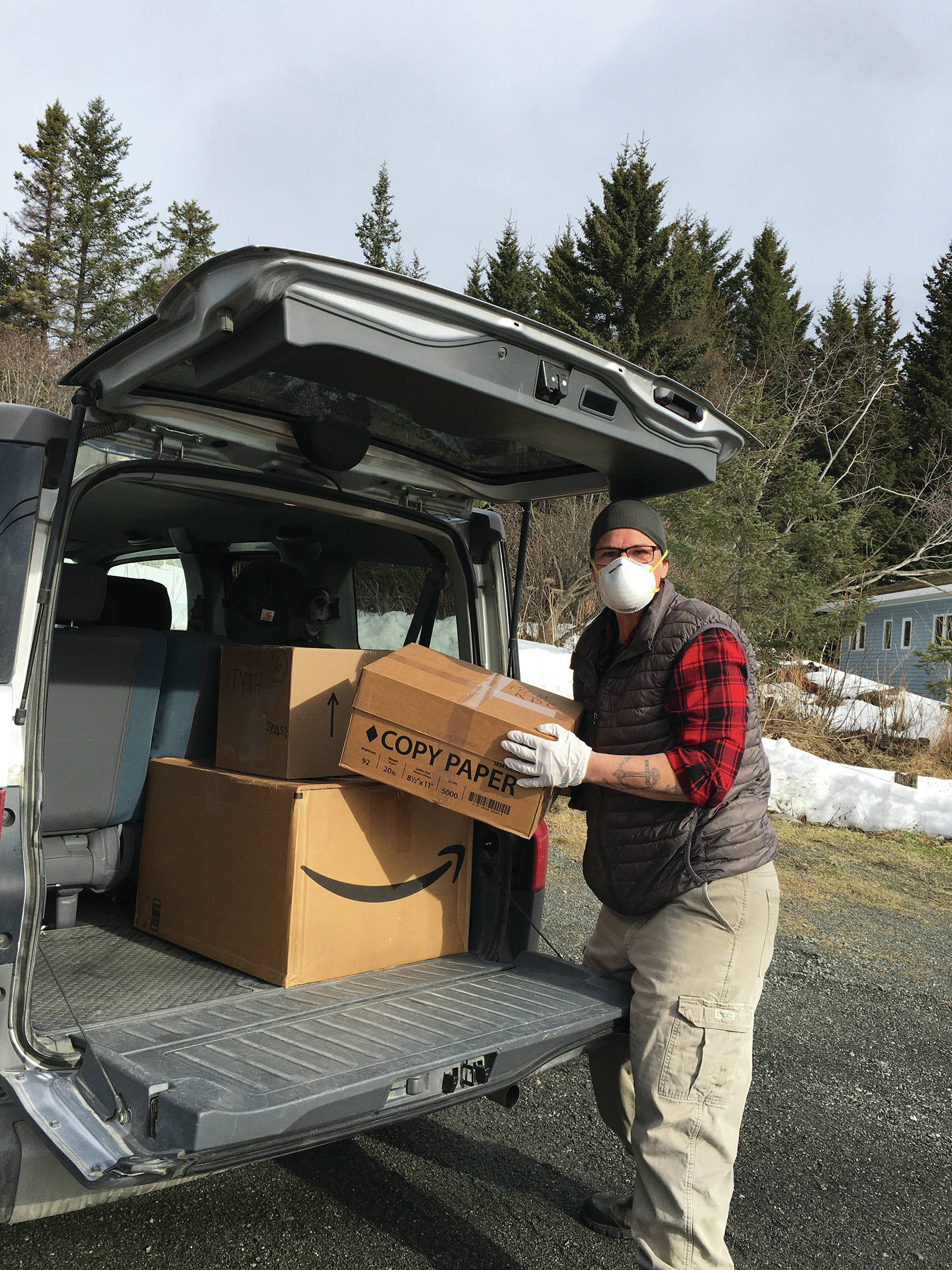 Michelle Melchert unloads personal protective gear donated by the Kachemak Bay Campus at South Peninsula Hospitla on Marh 25, 2020, in Homer, Alaska. (Photo courtesy Susan Kaplan)