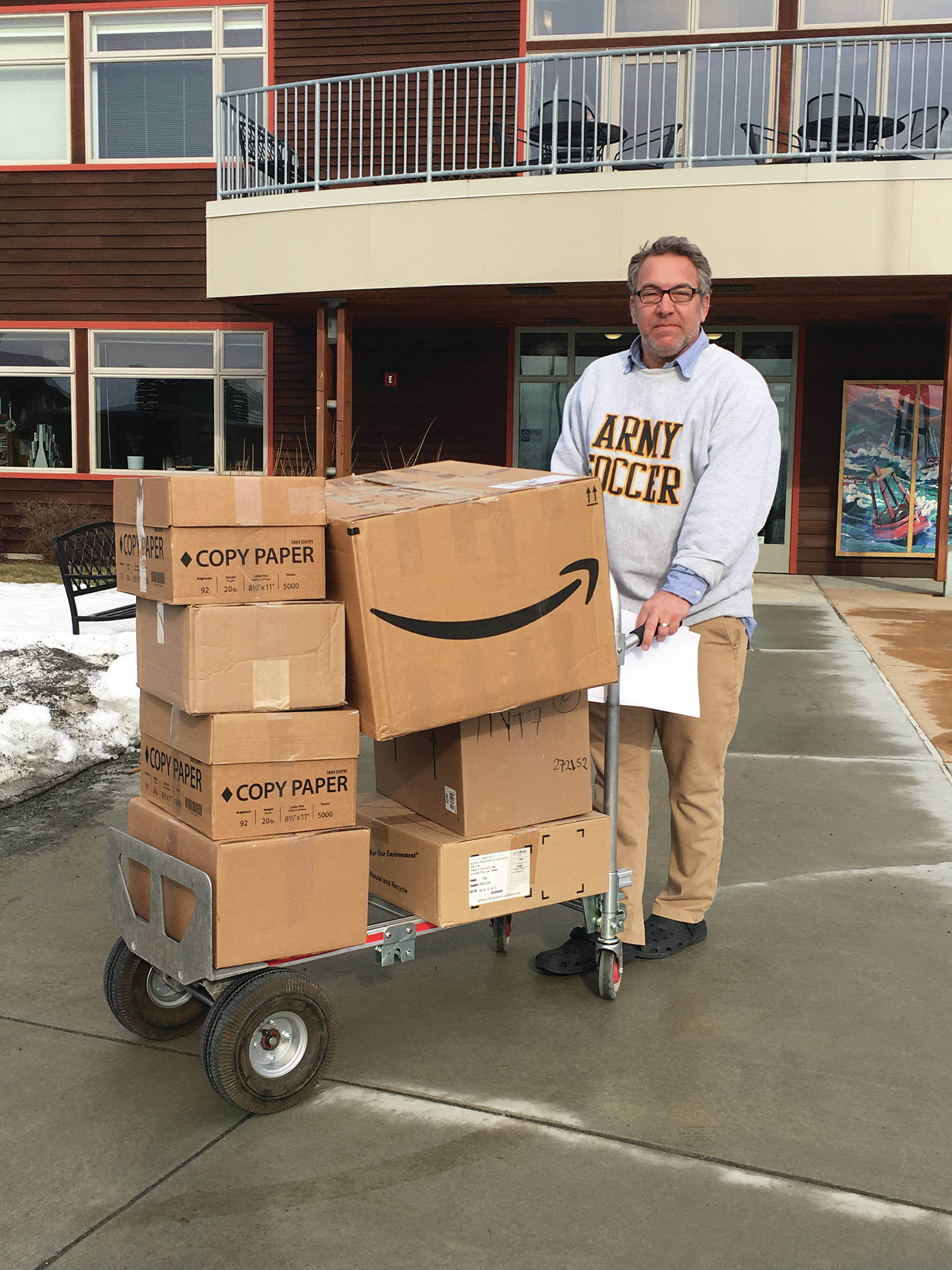 Kachemak Bay Campus Director Reid Brewer moves boxes of personal protective gear from the college for transport to South Peninsula Hospital on March 25, 2020, in Homer, Alaska. (Photo courtesy Susan Kaplan)