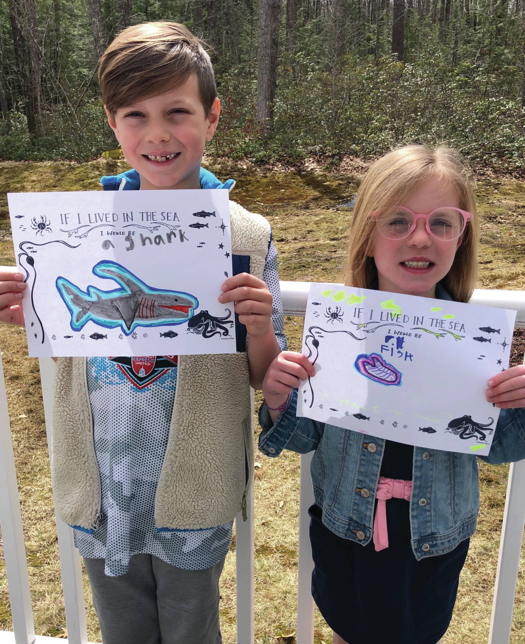Logan Cote, left, and Reese Cote, left, of Brookline, New Hampshire, hold up art they drew from the Salmon Sisters coloring pages while out of school in March during the COVID-19 pandemic. Their great aunt, Jenny Stroyeck, sent them the pages. Stroyeck is the wife of Homer News editor Michael Armstrong. (Photo courtesy Alana Cote)