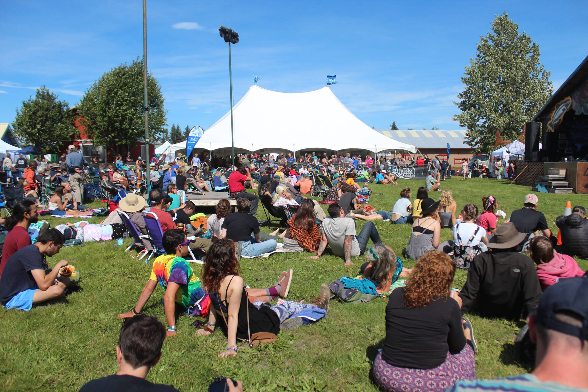 Spectators relax while listening to a musician at the Ocean Stage at last year’s Salmonfest on Friday, Aug. 2, 2019 in Ninilchik, Alaska. (Photo by Megan Pacer/Homer News)