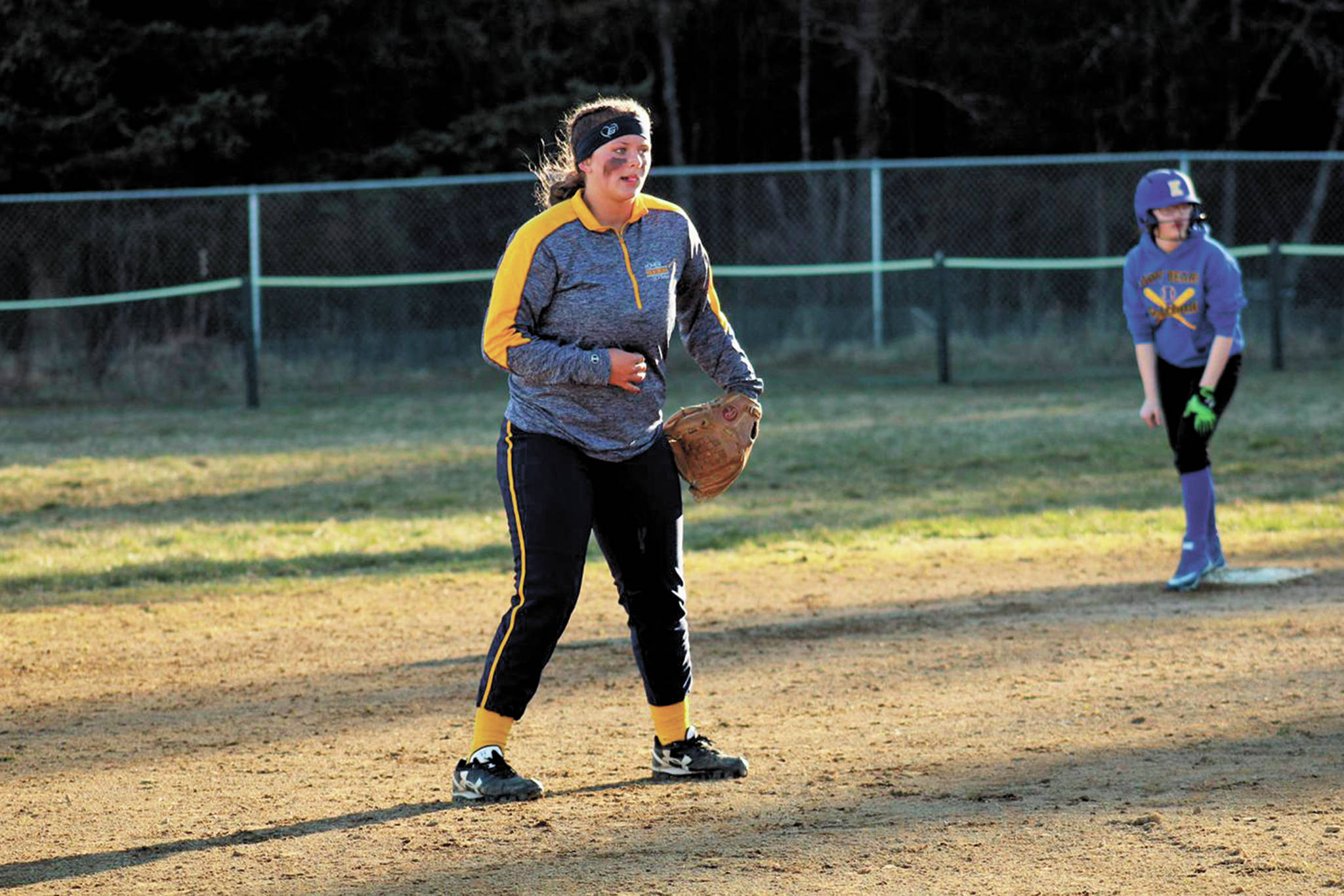 Photo courtesy Bill Bell                                 Kaitlyn Johnson plays with her teammates on the Homer softball team in this undated photo.