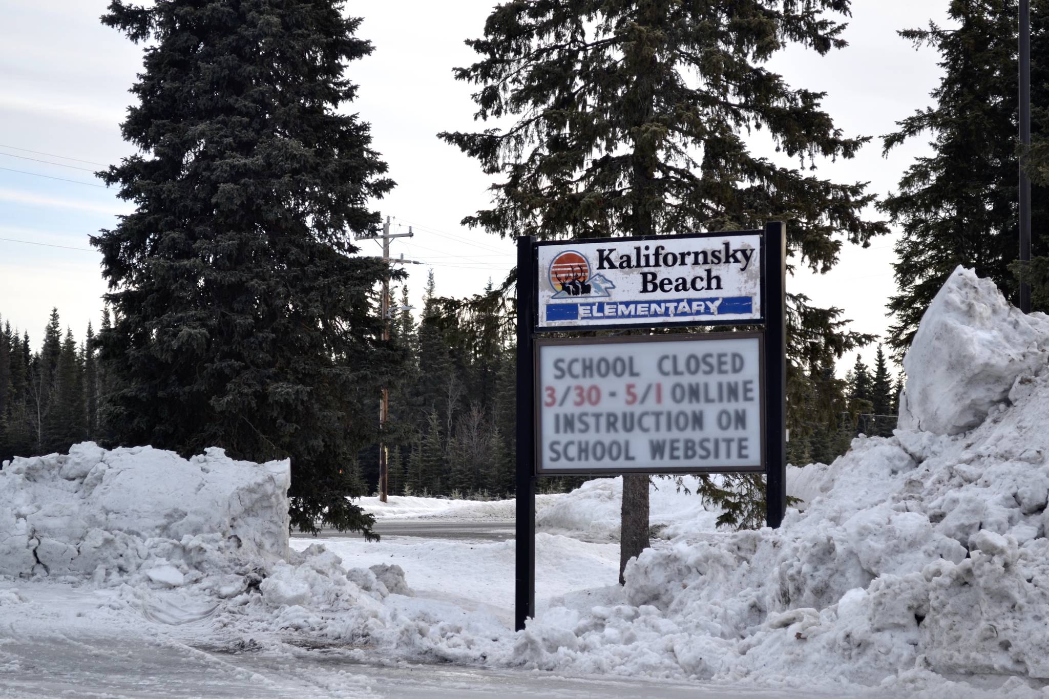 A sign announcing the closure of Kenai Peninsula Borough School District schools at K-Beach Elementary can be seen on March 26, 2020, near Soldotna, Alaska. (Victoria Petersen/Peninsula Clarion)