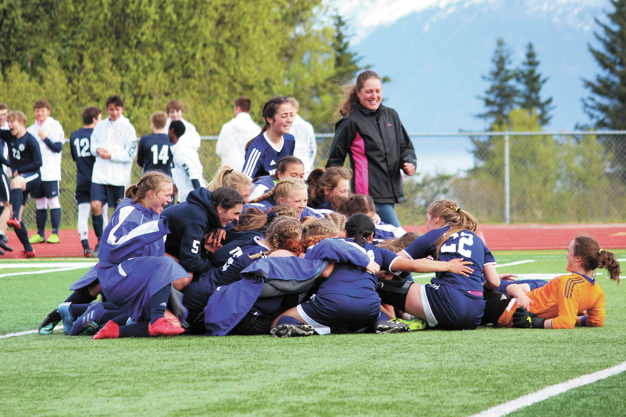 The Homer girls soccer team celebrates its 4-3 win over Kenai Central High School in the semi-final match of the Peninsula Conference Soccer Tournament on May 17, 2019 at Homer High School in Homer, Alaska. (Photo by Megan Pacer/Homer News)