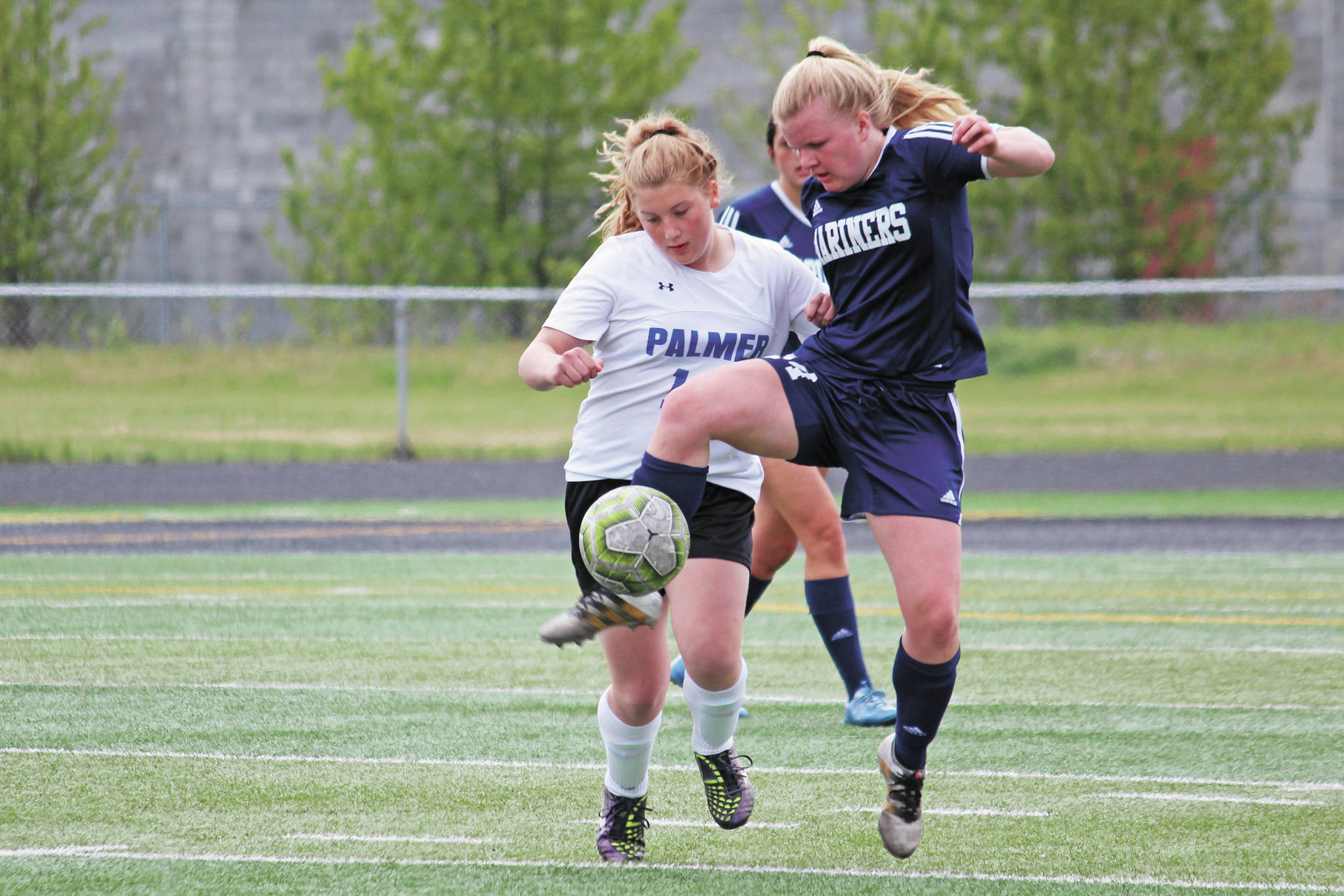 Homer’s Daisy Kettle battles for the ball with Palmer’s Avery Hill in a May 24, 2019 game during the Division II state soccer championship tournament at West Anchorage High School in Anchorage, Alaska. (Photo by Megan Pacer/Homer News)