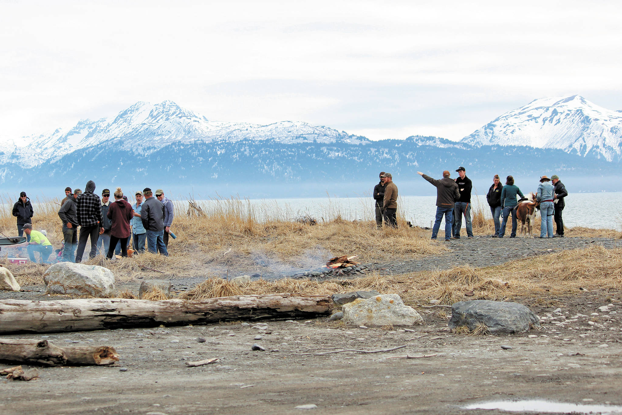 Participants in a community gathering and barbecue event spend time together on the beach Saturday, April 18, 2020 at Mariner Park in Homer, Alaska. The gathering was held by the Homer’s Sons of Liberty while the state health mandate that bans all in-person gatherings was still in place. (Photo by Megan Pacer/Homer News)