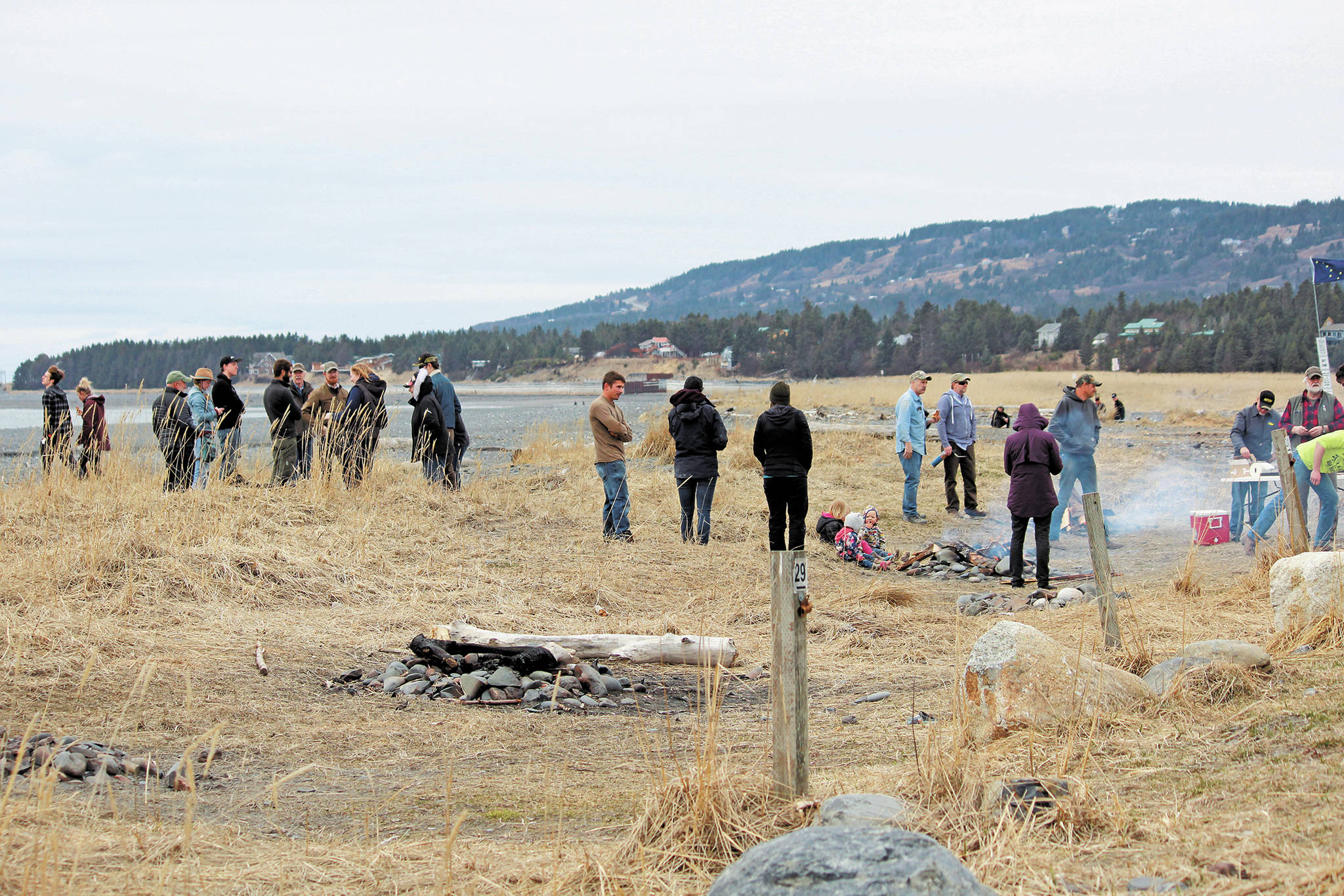 Participants in a community gathering and barbecue event spend time together on the beach Saturday, April 18, 2020 at Mariner Park in Homer, Alaska. The gathering was held by the Homer’s Sons of Liberty while the state health mandate that bans all in-person gatherings was still in place. (Photo by Megan Pacer/Homer News)