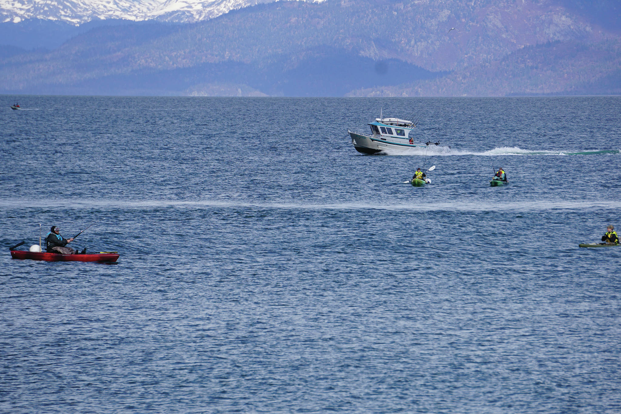 Fishermen in sit-on-top kayaks try their luck off the Homer Spit on Sunday afternoon, April 26, 2020, in Homer, Alaska. (Photo by Michael Armstrong/Homer News)