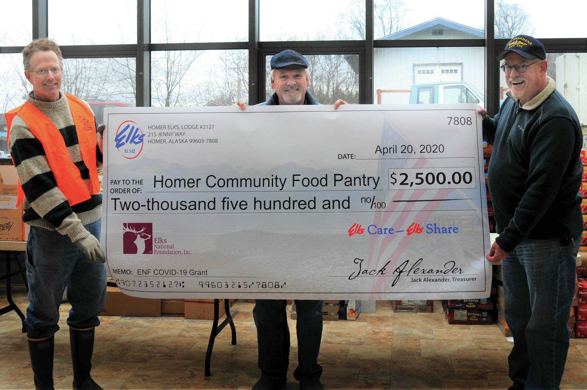 At left, Tom McDonough, President of the Homer Community Food Pantry, holds a check for a $2,500 donation to the food pantry from the Homer Elks Lodge #2127 given to the pantry on April 20, 2020, in Homer, Alaska. At center is Tom Stroozas, Homer Elks Grant Coordinator, and at right is Steve Mueller, President of Homer Elks Lodge. (Photo courtesy Homer Elks Lodge)