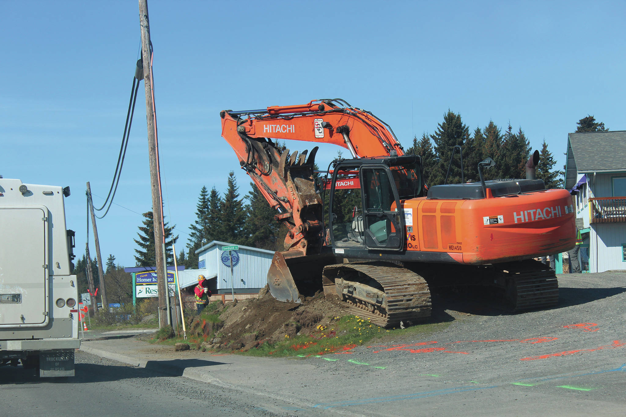 Construction work is performed at the corner of Pioneer Avenue and Svedlund Street on Wednesday, May 13, 2020 in Homer, Alaska. (Photo by Megan Pacer/Homer News)