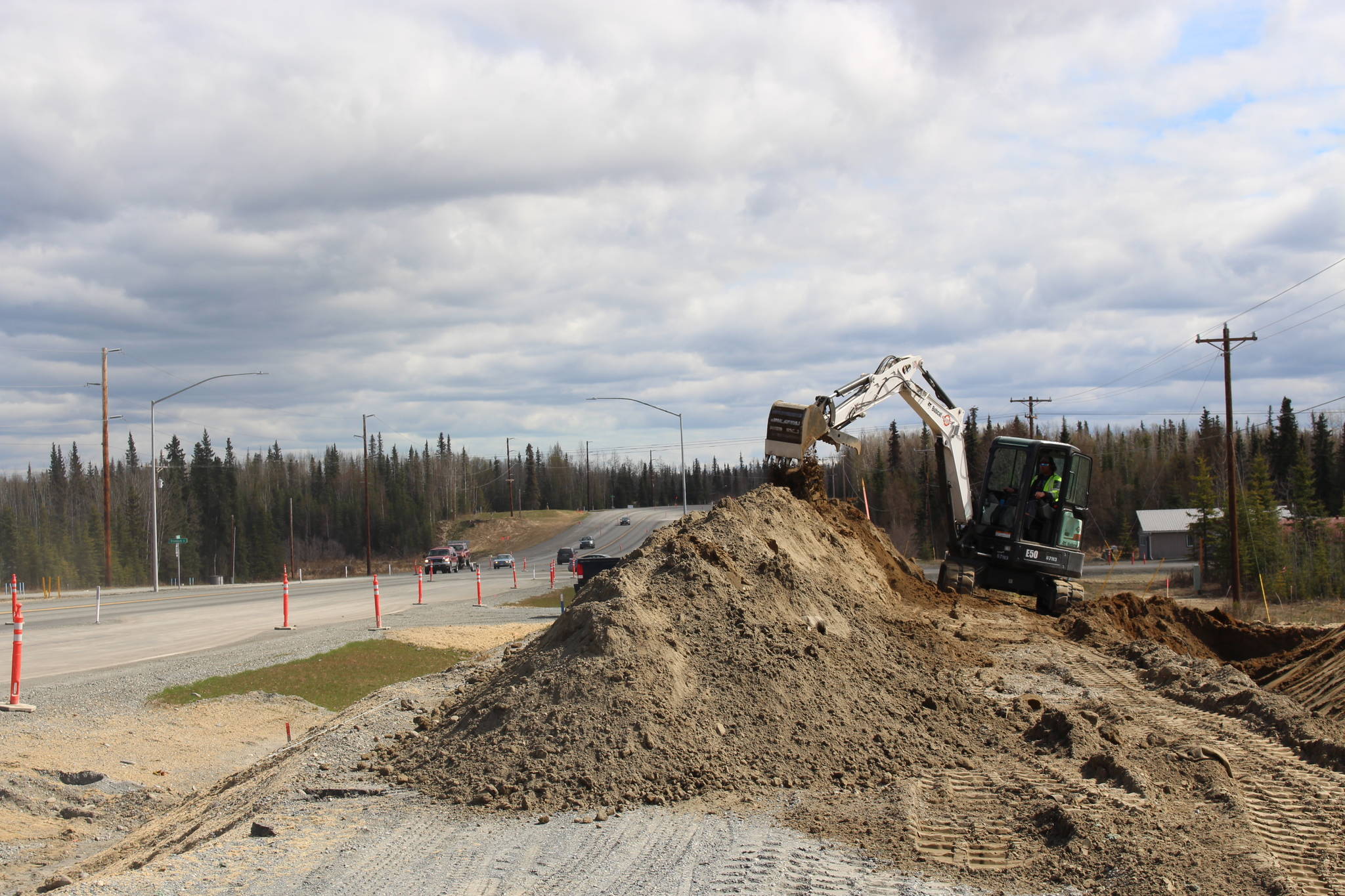 Construction crews are seen here working along the Kenai Spur Highway in Kenai, Alaska, on May 12, 2020. (Photo by Brian Mazurek/Peninsula Clarion)