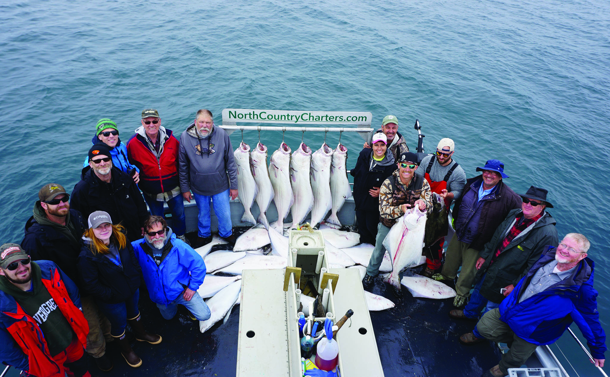 Anglers stand by a rack of halibut on the Irish as the North Country Charters boat returned to Homer, Alaska, in July 2017. Keeping people socially distant is one challenge charter captains face. (Photo by Michael Armstrong/Homer News file photo)