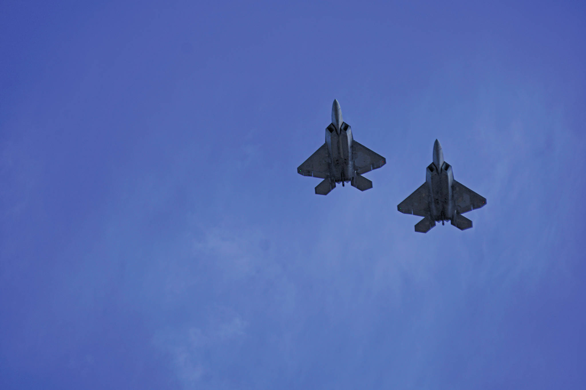 Two of four F-22 Raptors from the U.S. Air Force 3rd wing, Joint Base Elmendorf Richardson, fly over downtown Homer, Alaska on Friday, May 15, 2020, as part of an exercise to honor Alaska first responders and health care workers. (Photo by Michael Armstrong/Homer News)