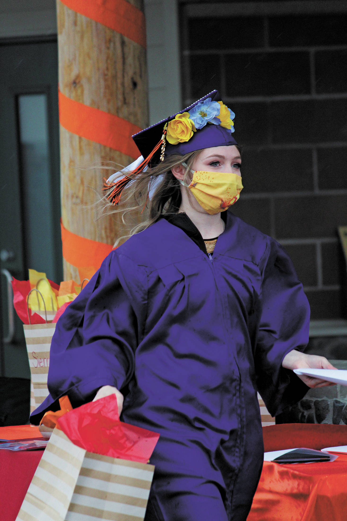 Homer Flex graduate Autumn Carlson collects her diploma during an alternative graduation ceremony for the school on Monday, May 18, 2020 at the Homer Harbor in Homer, Alaska. (Photo by Megan Pacer/Homer News)