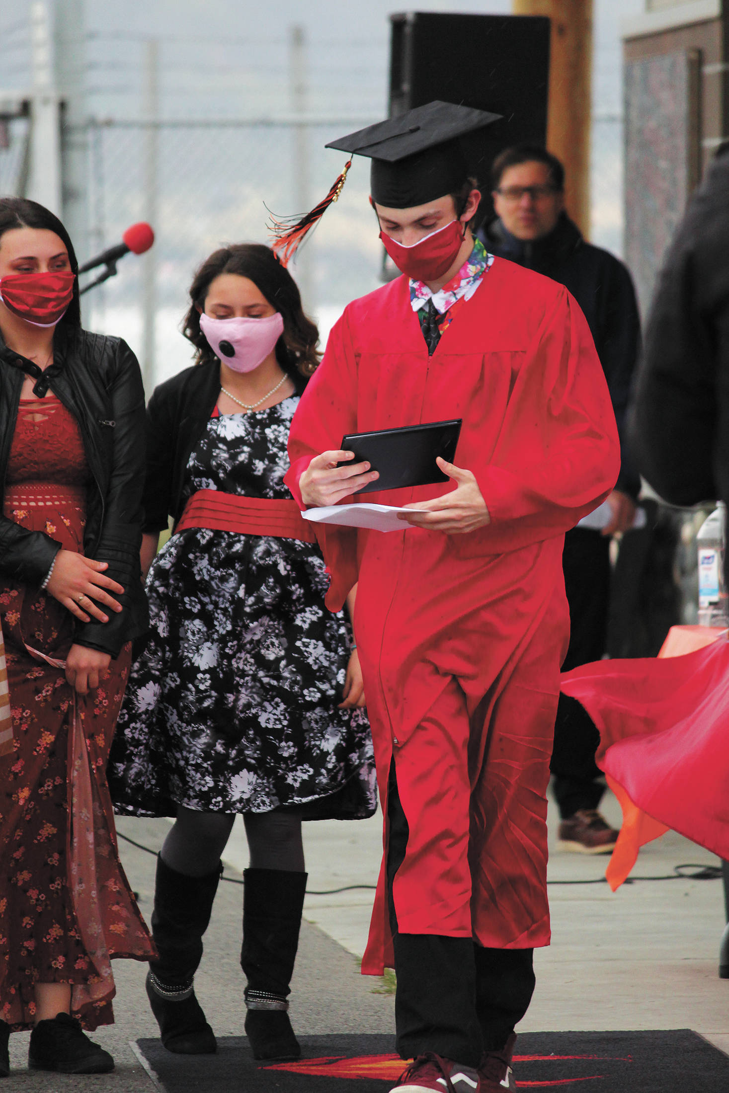Homer Flex School graduate Jonathen Bice-Dee collects his diploma with friends and members of his family during a Monday, May 18, 2020 graduation ceremony for the school at the Homer Harbor in Homer, Alaska. (Photo by Megan Pacer/Homer News)