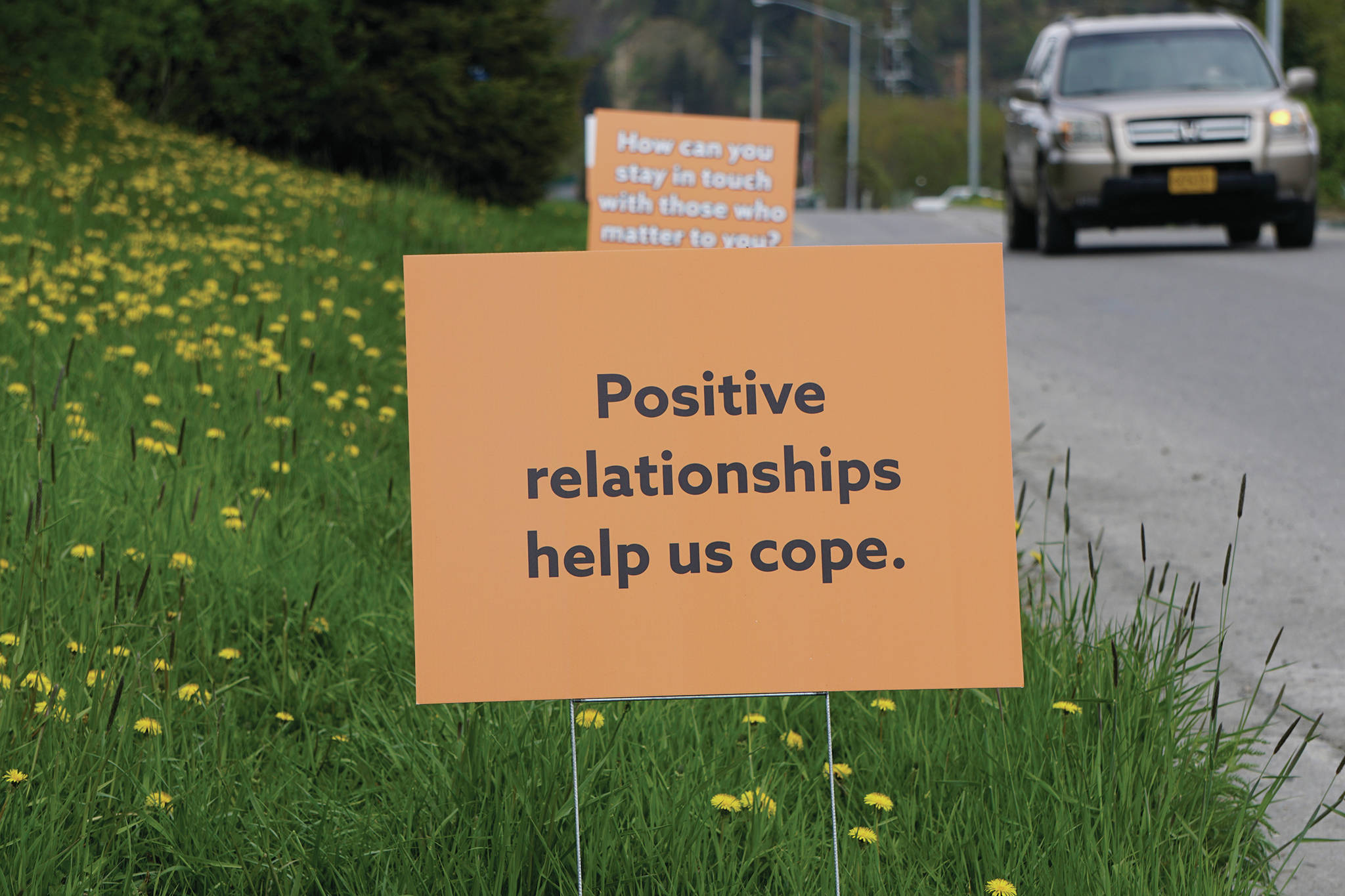 A series of signs on May 22, 2020, line Heath Street by the Homer Public Library in Homer, Alaska. Put up by the South Kenai Peninsula Resiliency Coalition, they read “Right now you may be feeling stress. Positive relationships help us cope. How can you stay in touch with those who matter to you?” (Photo by Michael Armstrong/Homer News)