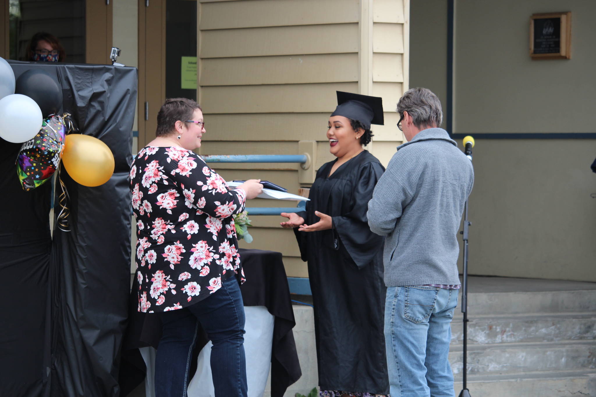 Denali Jackson receives her diploma from her mom, Leah, during the Connections Homeschool Class of 2020 graduation at Soldotna Elementary School in Soldotna, Alaska on May 21, 2020. (Photo by Brian Mazurek/Peninsula Clarion)