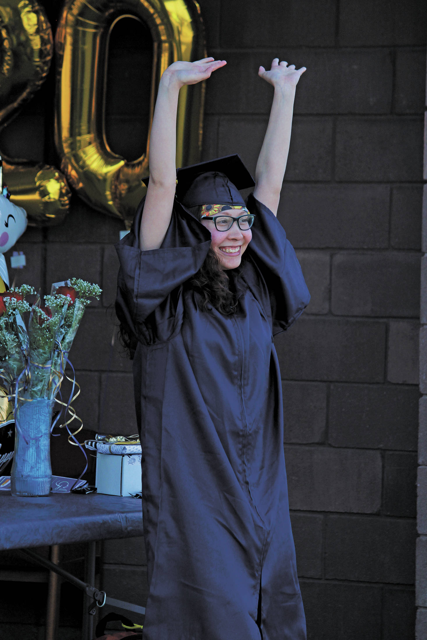 Ninilchik School graduate Anastacia Mata celebrates collecting her diploma in a Wednesday, May 20, 2020 alternative graduation ceremony at the school in Ninilchik, Alaska. (Photo by Megan Pacer/Homer News)