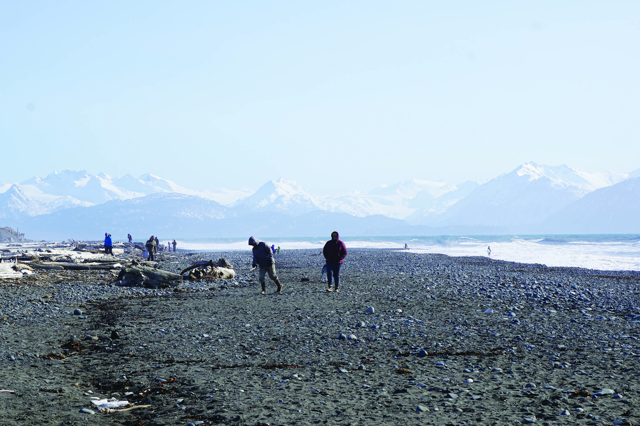 Beach walkers spread out at Bishop’s Beach on Sunday, March 22, 2020, in Homer, Alaska. During the pandemic, many fitness buffs have taken to the beach for exercise.(Photo by Michael Armstrong/Homer News)