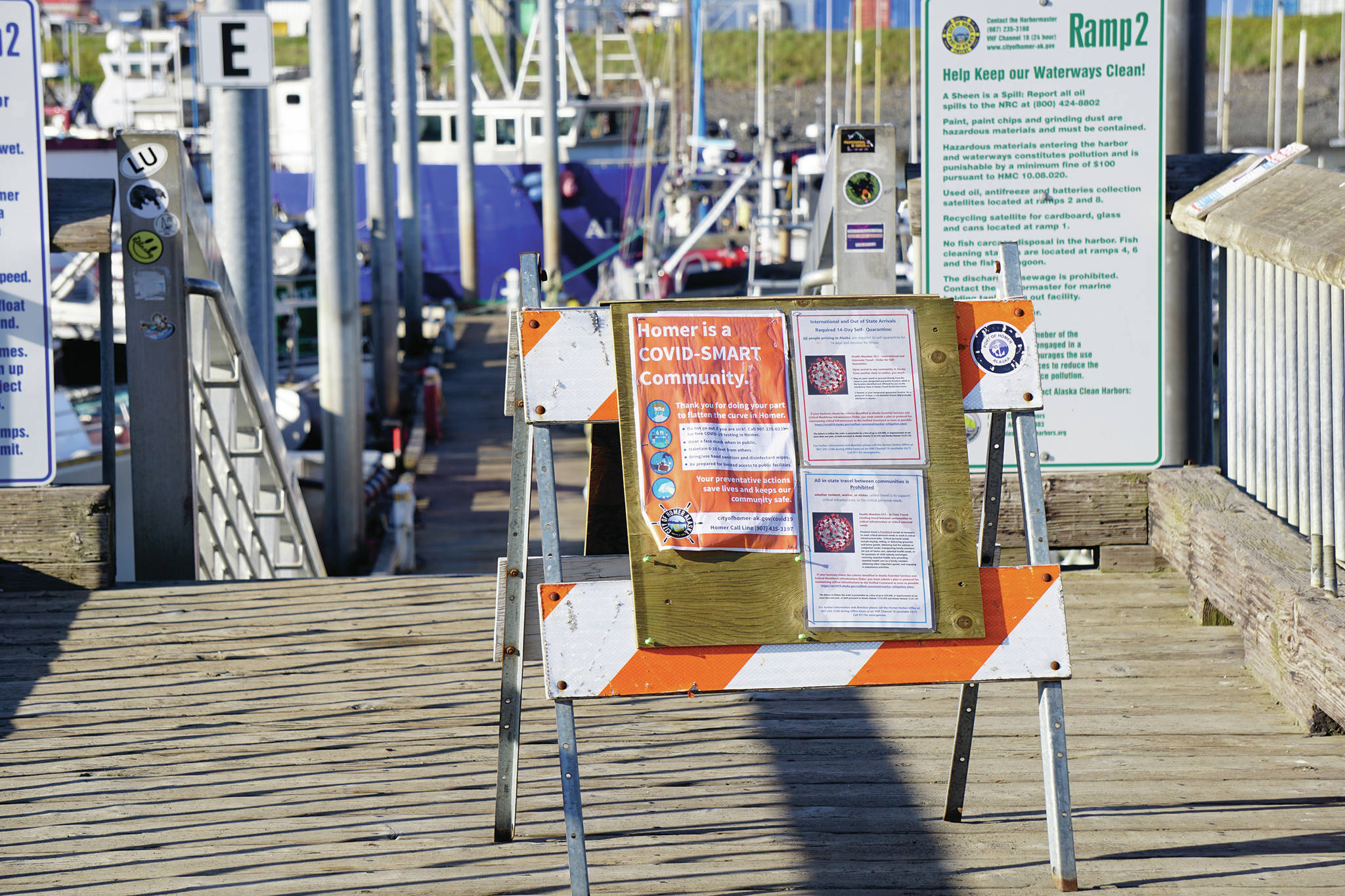 Signs at the Homer Harbor advise harbor users and visitors of COVID-19 information and resources on Sunday, May 24, 2020, in Homer, Alaska. (Photo by Michael Armstrong/Homer News)