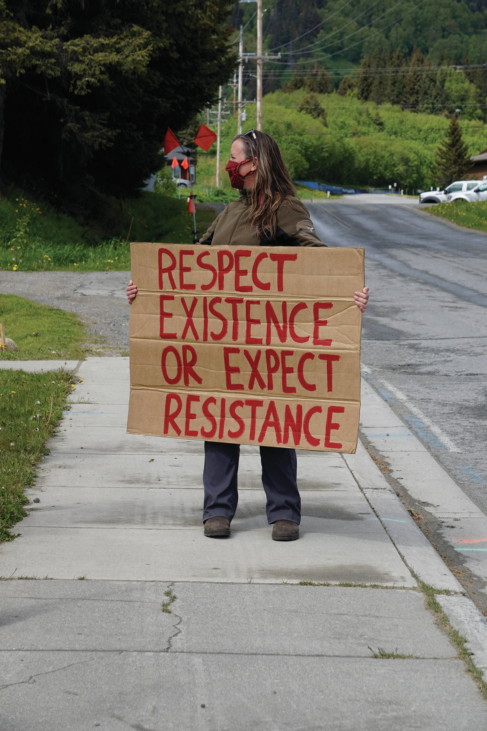 Jeni Stow holds a sign at a protest on Sunday, May 30, 2020, at WKFL Park in Homer, Alaska, in support of people of color who have been the subject of police violence, including George Floyd, a man who died May 25, 2020, in a police encounter in Minneapolis, Minnesota. (Photo by Michael Armstrong/Homer News)