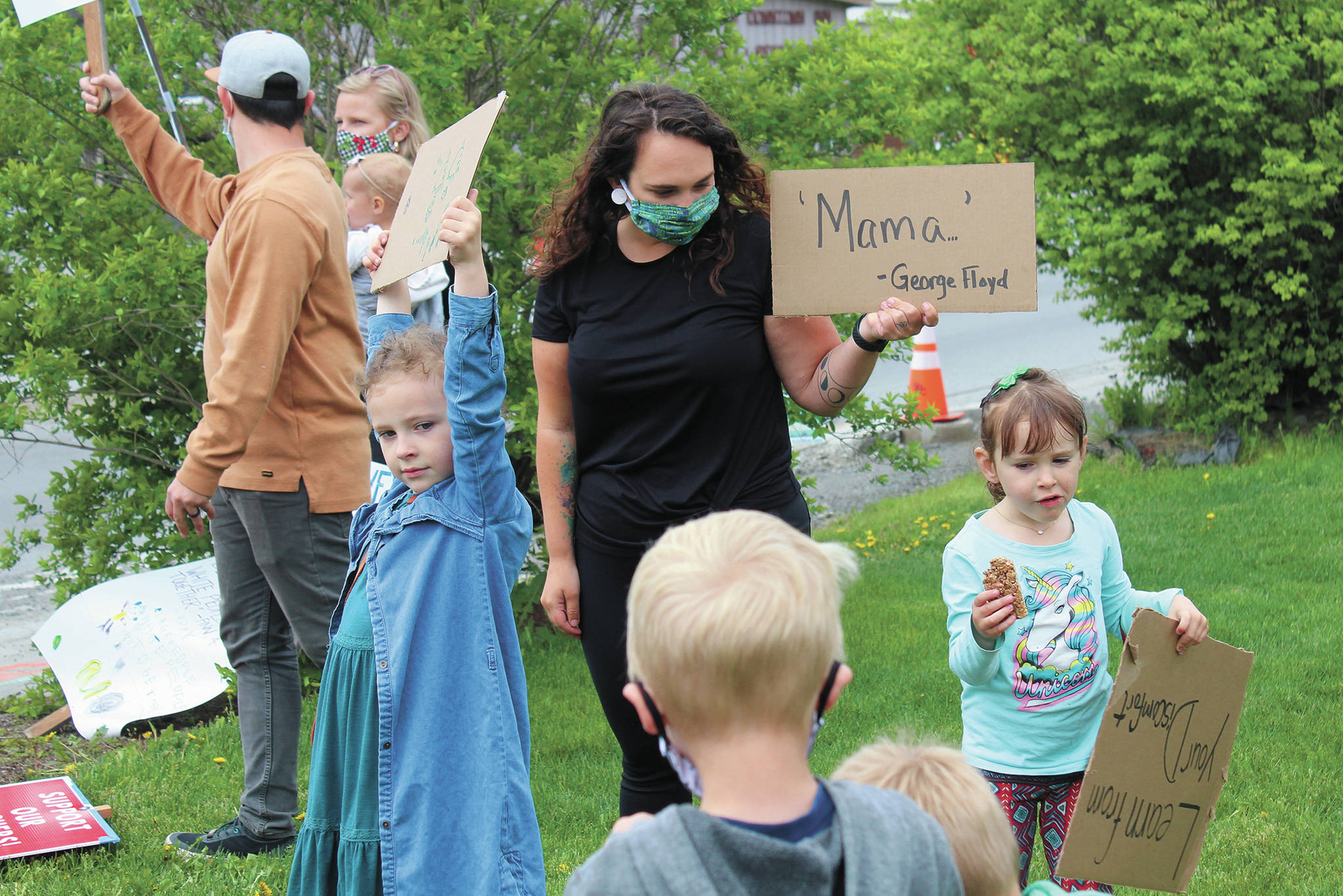 A woman holds a sign that reads “Mama,” which was one of the last words of George Floyd before he died in police custody in Minneapolis, Minnesota last week. Several families with young children participated in a Black Lives Matter demonstration Tuesday, June 2, 2020 at WKFL Park in Homer, Alaska. (Photo by Megan Pacer/Homer News)