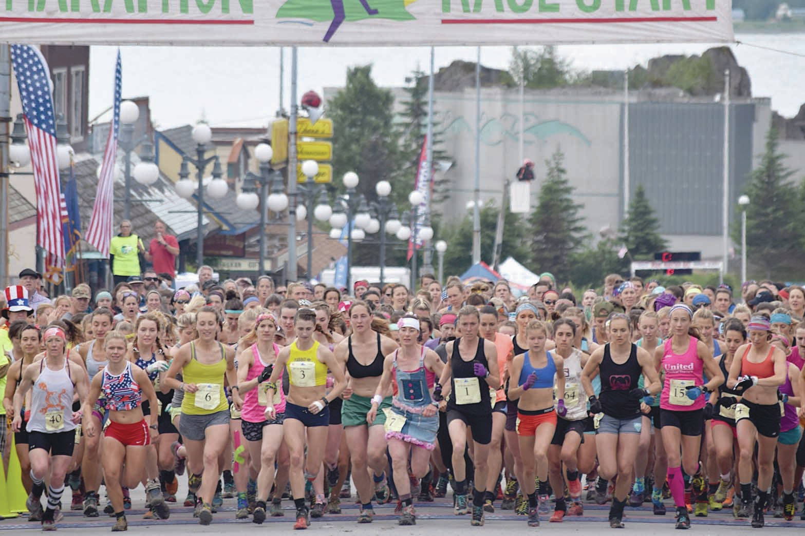 The women’s field takes to the course Tuesday, July 4, 2017, at the Mount Marathon Race in Seward, Alaska. Eventual winner Allie Ostrander is to the right of Christy Marvin (1). (Photo by Jeff Helminiak/Peninsula Clarion)
