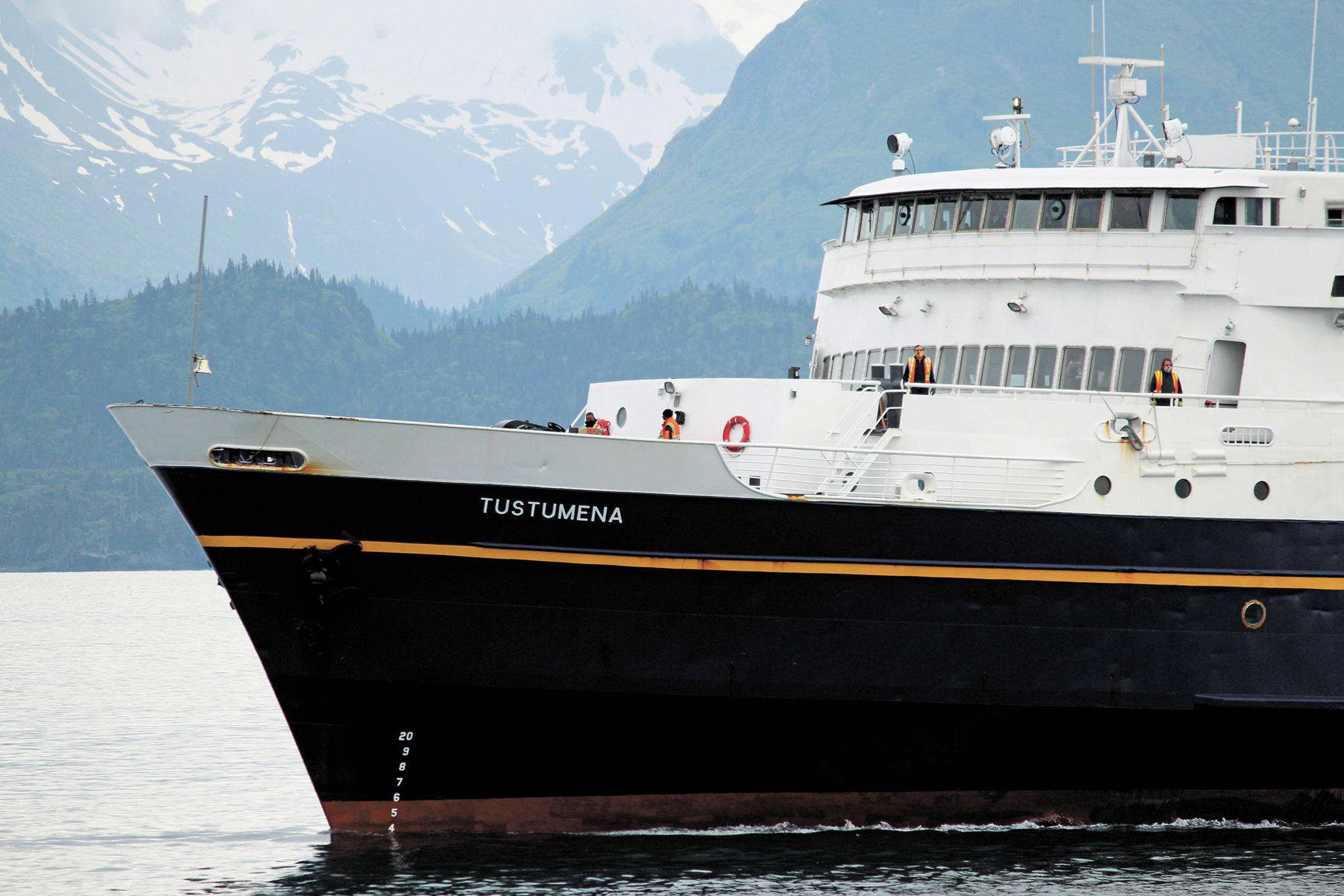Crew members move about the bow of the M/V Tustumena as it pulls into the Homer Harbor on Monday, June 8, 2020 in Homer, Alaska. A member of the crew tested positive for COVID-19 on Saturday when the state ferry was docked in Dutch Harbor, and most of the crew and six passengers who had boarded in Homer were quarantined while the ship returned. Local health workers performed COVID-19 tests on the crew and passengers upon docking, and they were only allowed to disembark if they had private transportation to their final quarantine destination. (Photo by Megan Pacer/Homer News)