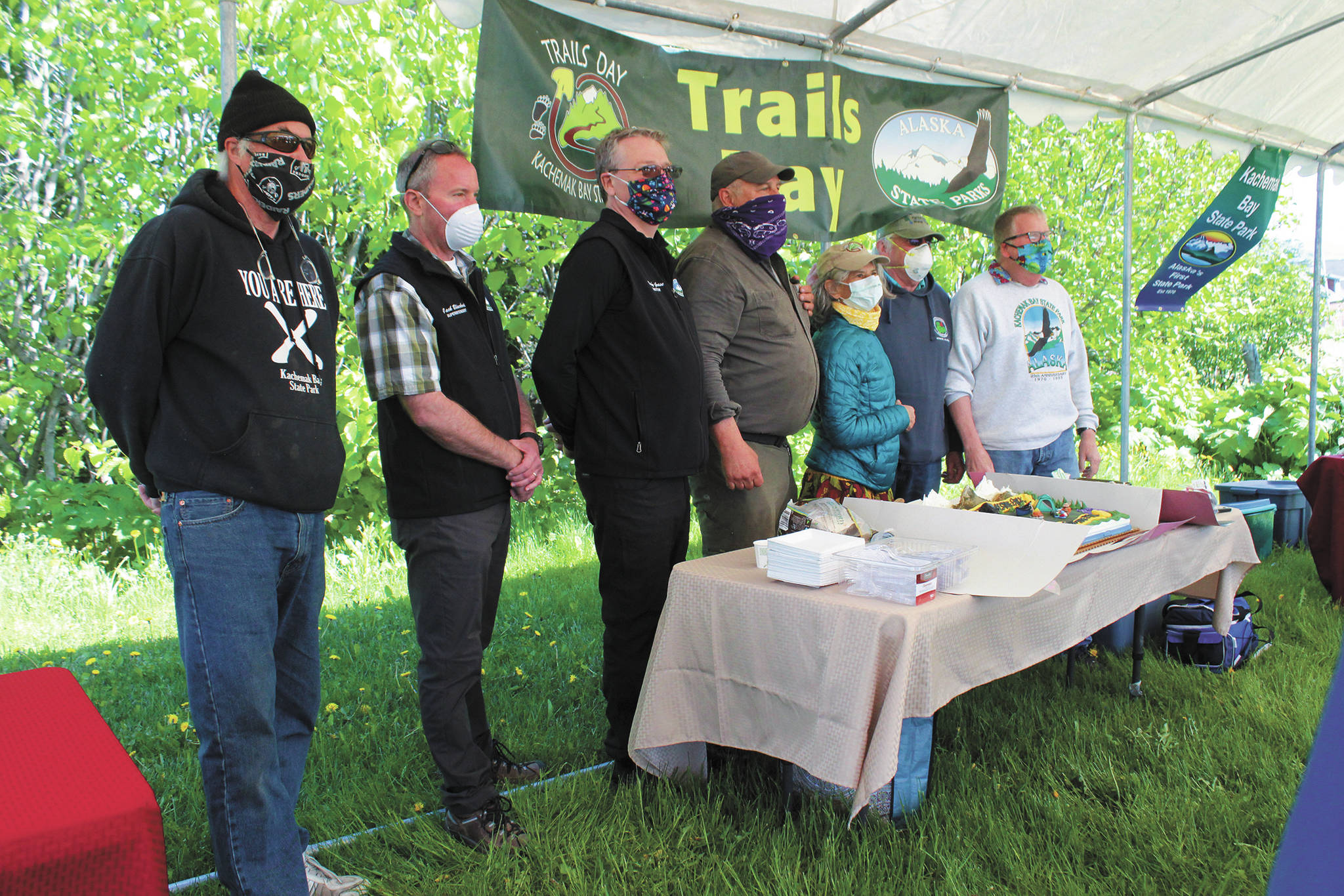A group of supporters, volunteers, and Alaska Department of Natural Resources staff celebrate the 50th anniversary of Kachemak Bay State Park during a small gathering Saturday, June 6, 2020 at the Homer Chamber of Commerce & Visitor Center in Homer, Alaska. (Photo by Megan Pacer/Homer News)