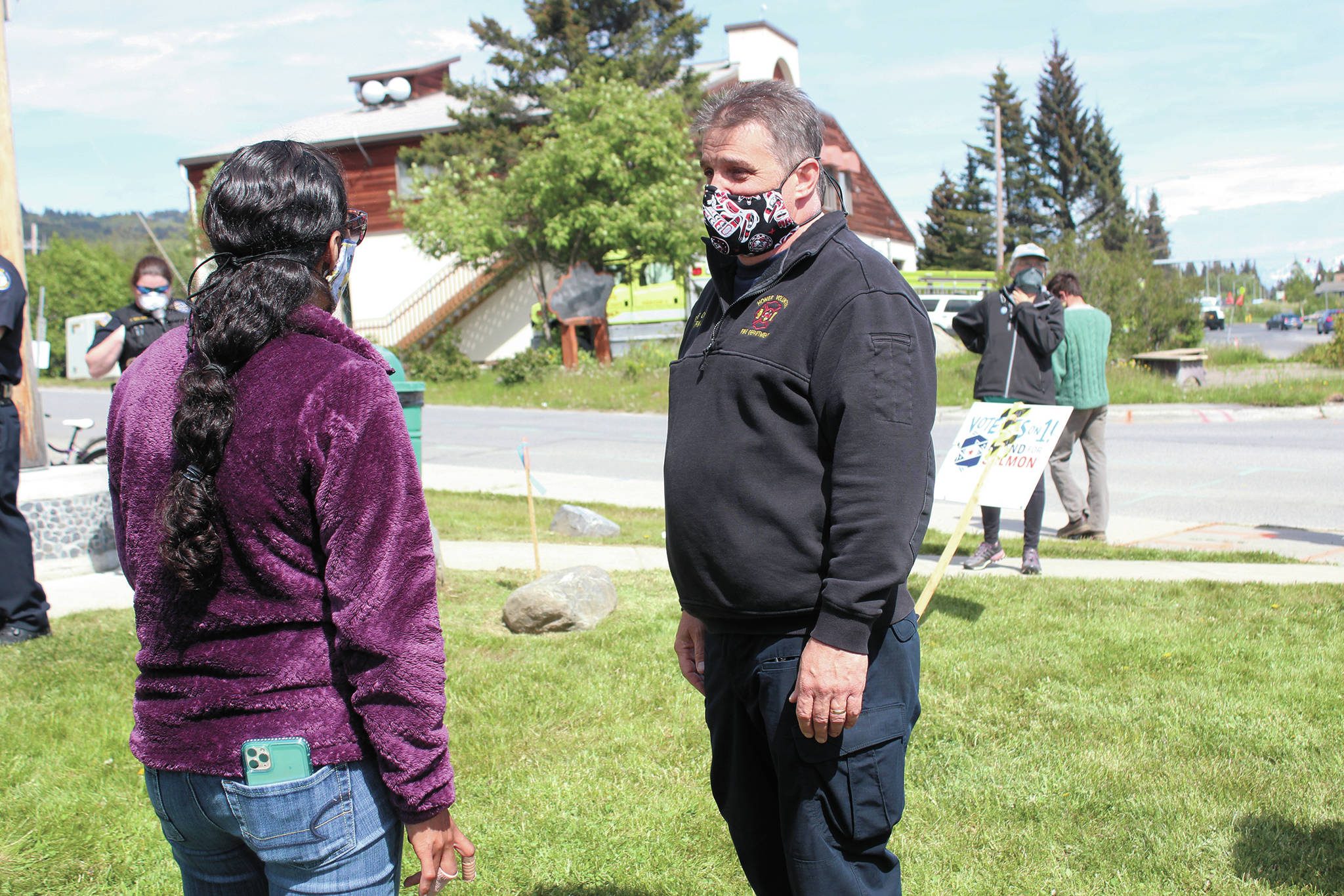 Winter Marshall-Allen (left) speaks with Homer Volunteer Fire Department Chief Mark Kirko during a protest supporting the Black Lives Matter movement Thursday, June 4, 2020 at WKFL Park in Homer, Alaska. (Photo by Megan Pacer/Homer News)