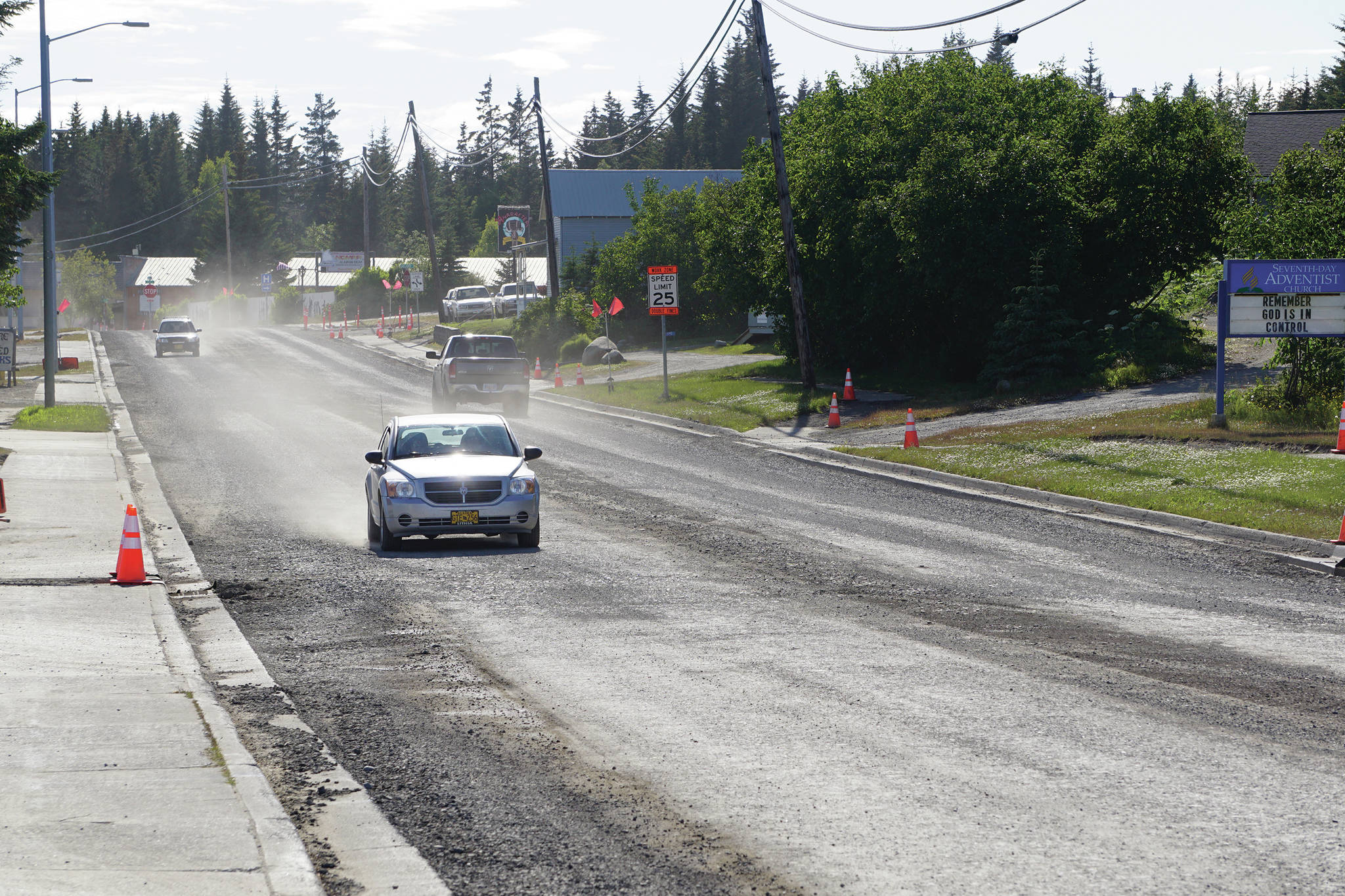 A driver heads east on Pioneer Avenue toward Svedlund Street on Monday, June 22, 2020, in Homer, Alaska. The road has been torn up as part of a repaving project for Pioneer Avenue. (Photo by Michael Armstrong/Homer News)