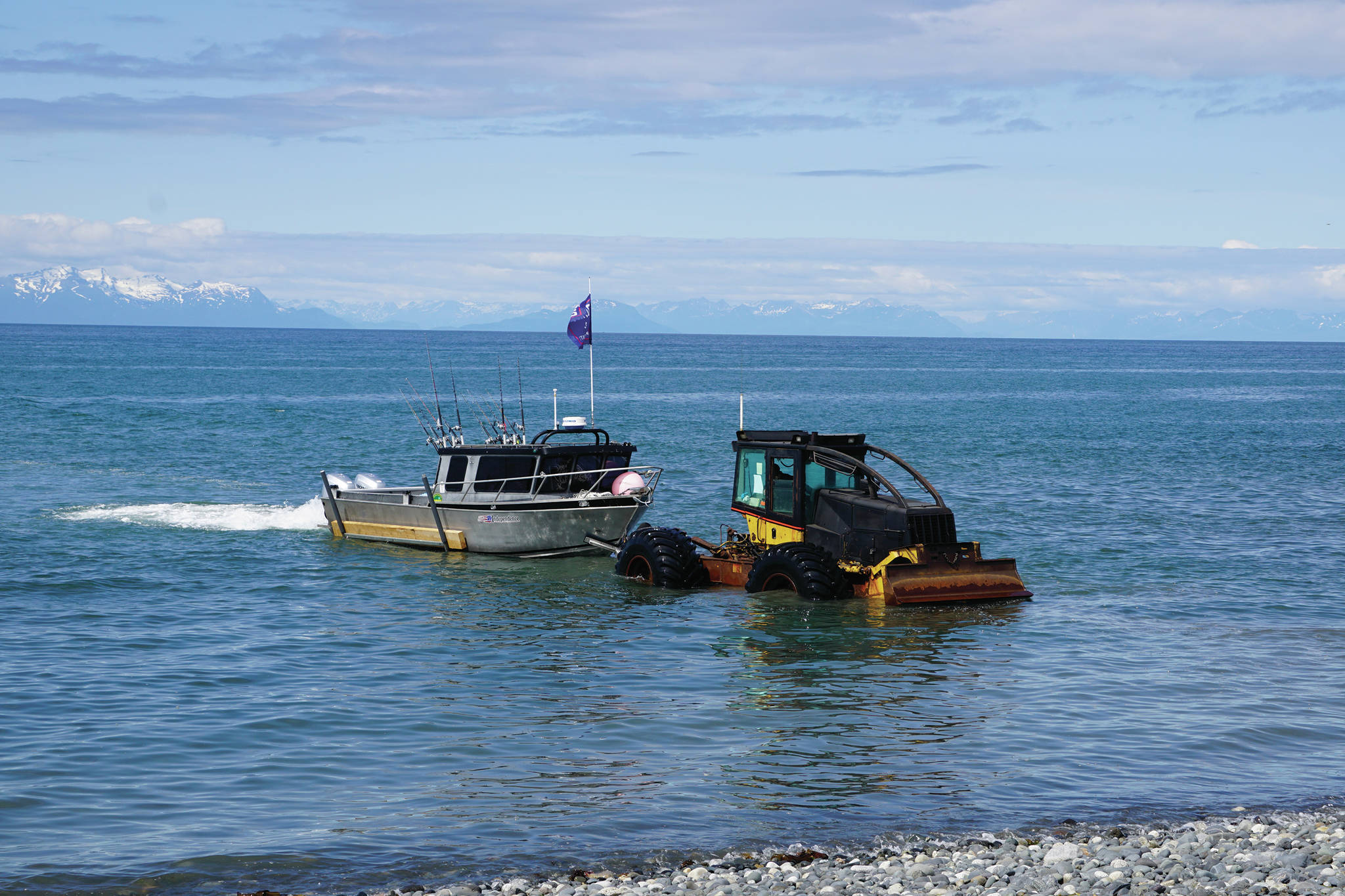 A tractor with the Anchor Point Tractor Launch pulls a fishing boat out of the water on Saturday, June 20, 2020, at the beach in Anchor Point, Alaska. (Photo by Michael Armstrong/Homer News)