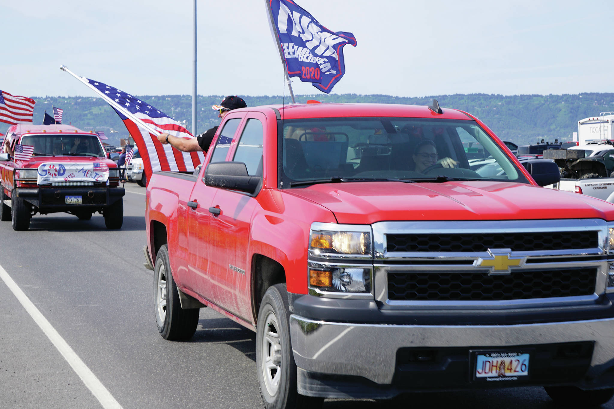 A woman drives a truck with a “Trump 2020” flag on July 4, 2020, part of an Independence Day parade on Saturday, July 4, 2020 that went from Soundview Avenue on the Sterling Highway to the end of the Homer Spit in Homer, Alaska. (Photo by Michael Armstrong/Homer News)