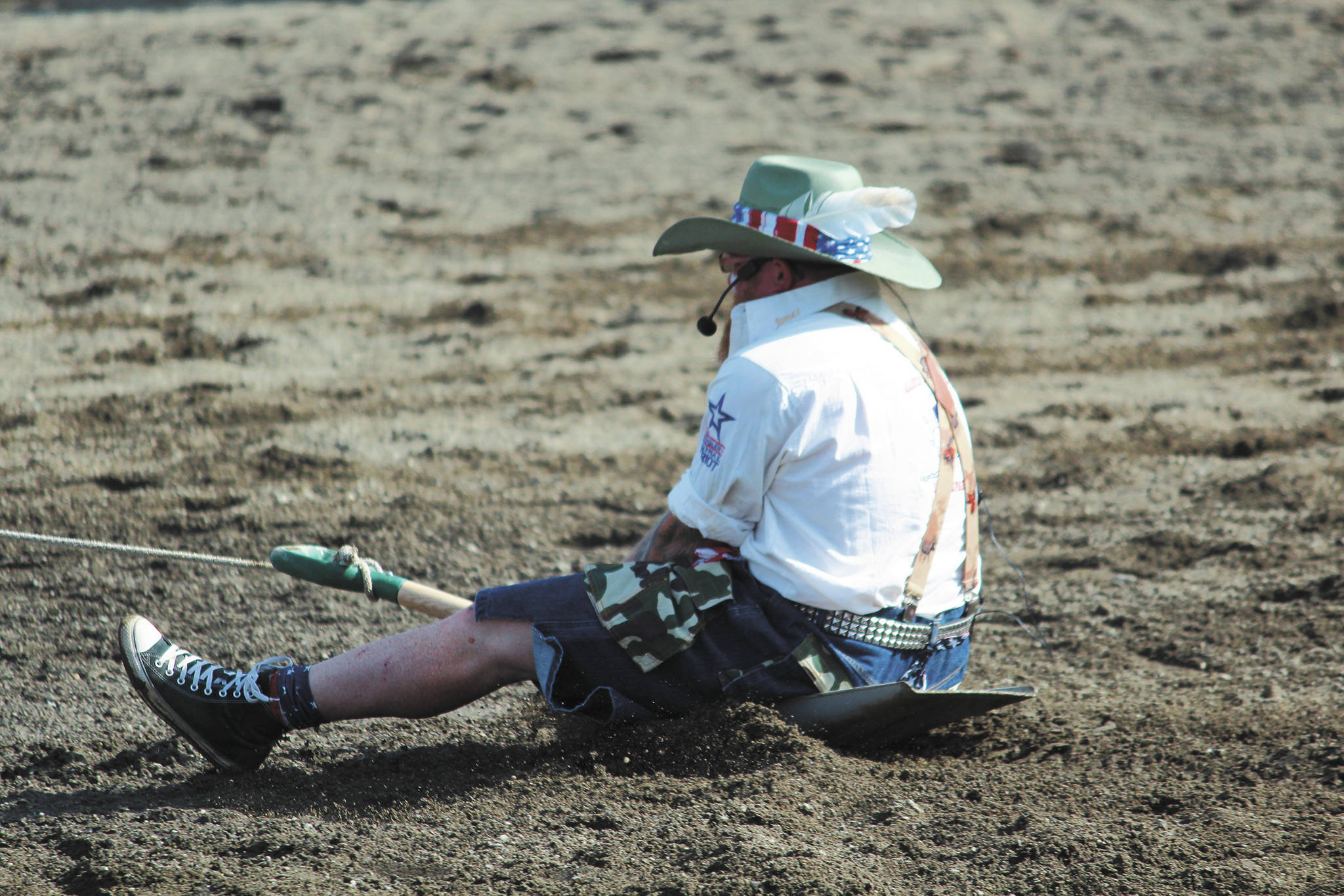 Rodeo announcer James Hastings is pulled behind a horse during the shovel race at the annual Ninilchik Rodeo on Saturday, July 4, 2020 at the Kenai Peninsula Fairgrounds in Ninilchik, Alaska. (Photo by Megan Pacer/Homer News)