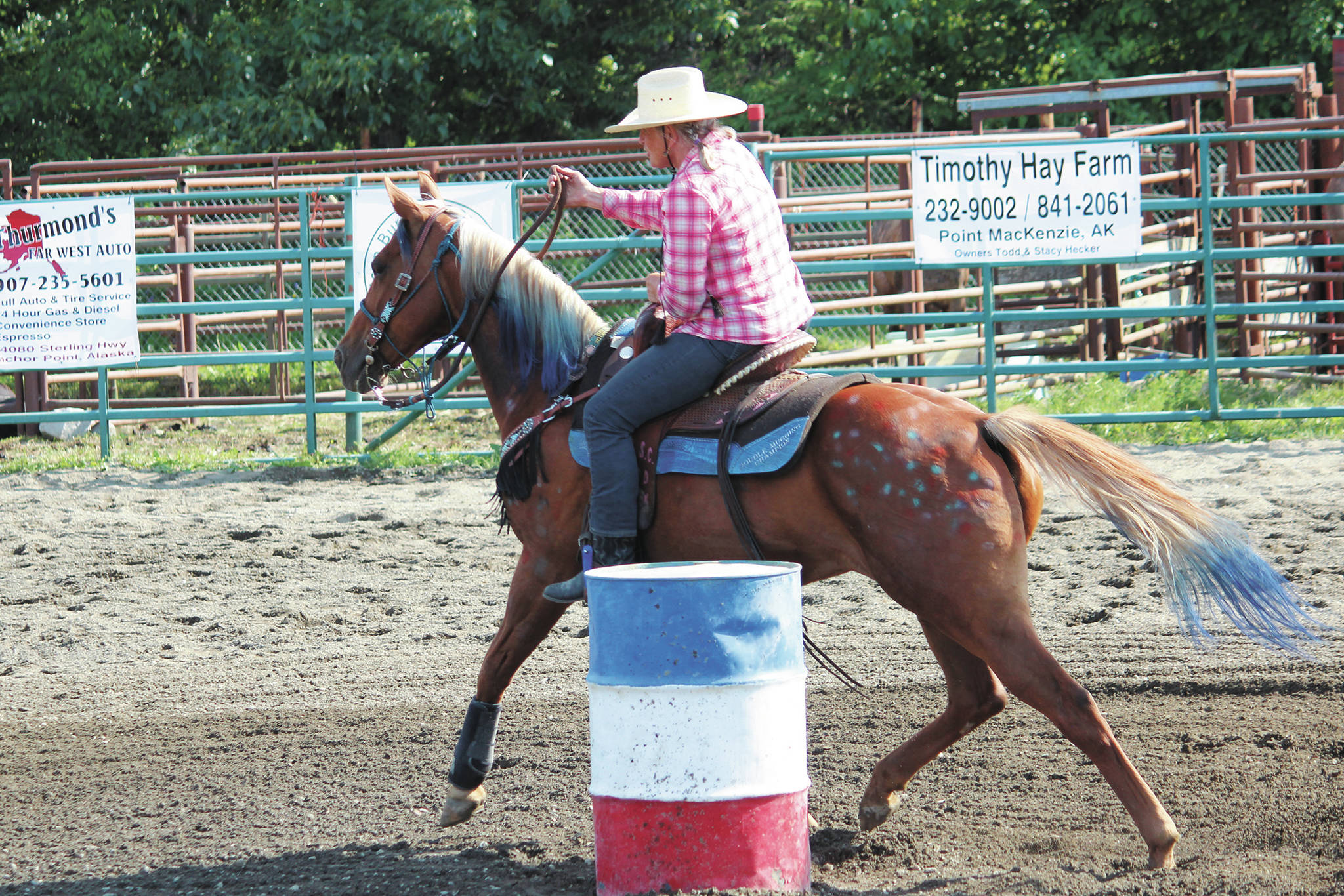 Naida McGee, of Anchorage, leads her horse through the barrel race at this year’s Ninilchik Rodeo on Saturday, July 4, 2020 at the Kenai Peninsula Fairgrounds in Ninilchik, Alaska. (Photo by Megan Pacer/Homer News)