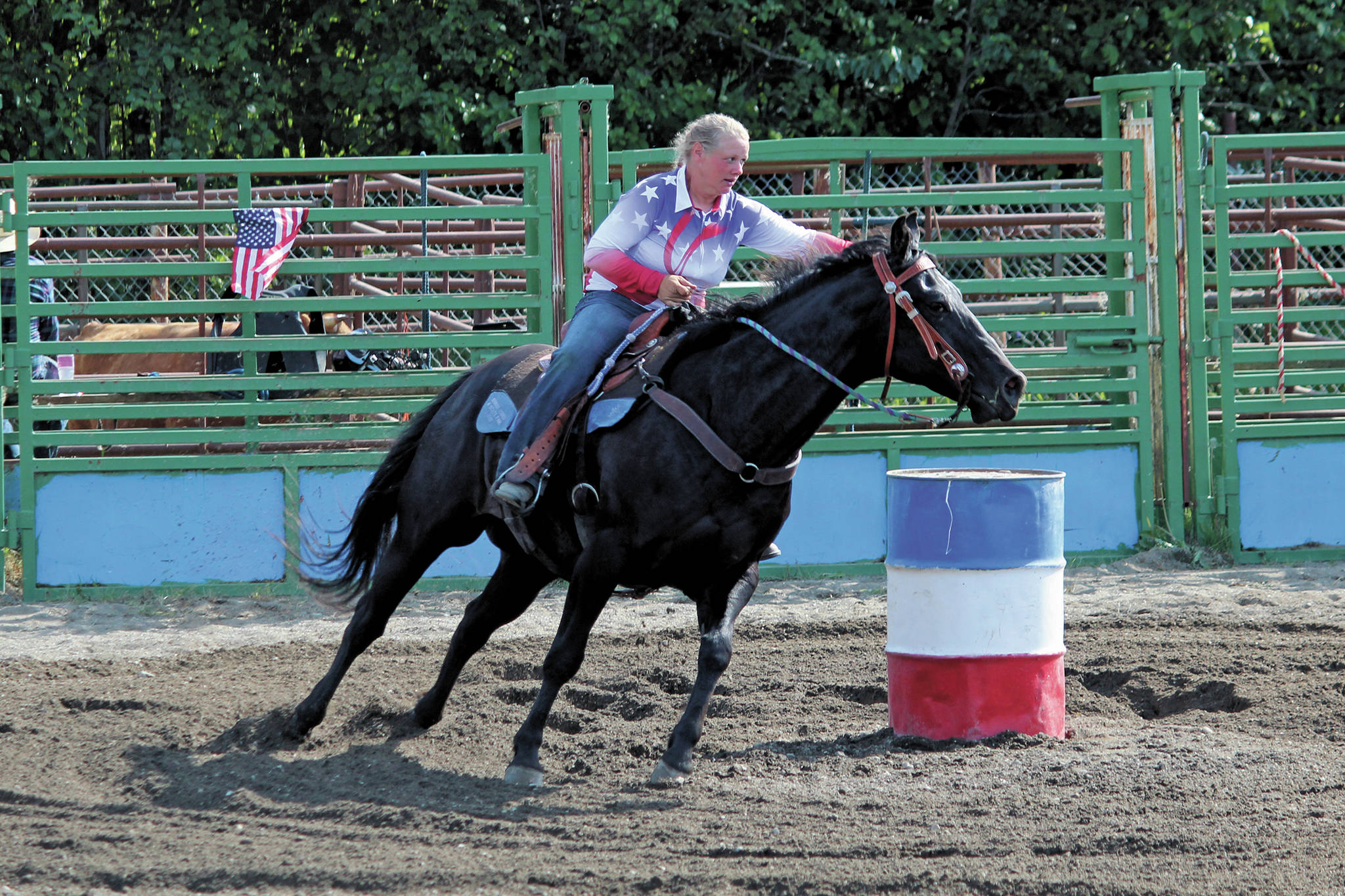 Katy Jones, of the Homer area, rides her horse Bo through a barrel race Saturday, July 4, 2020 during the Ninilchik Rodeo at the Kenai Peninsula Fairgrounds in Ninilchik, Alaska. (Photo by Megan Pacer/Homer News)