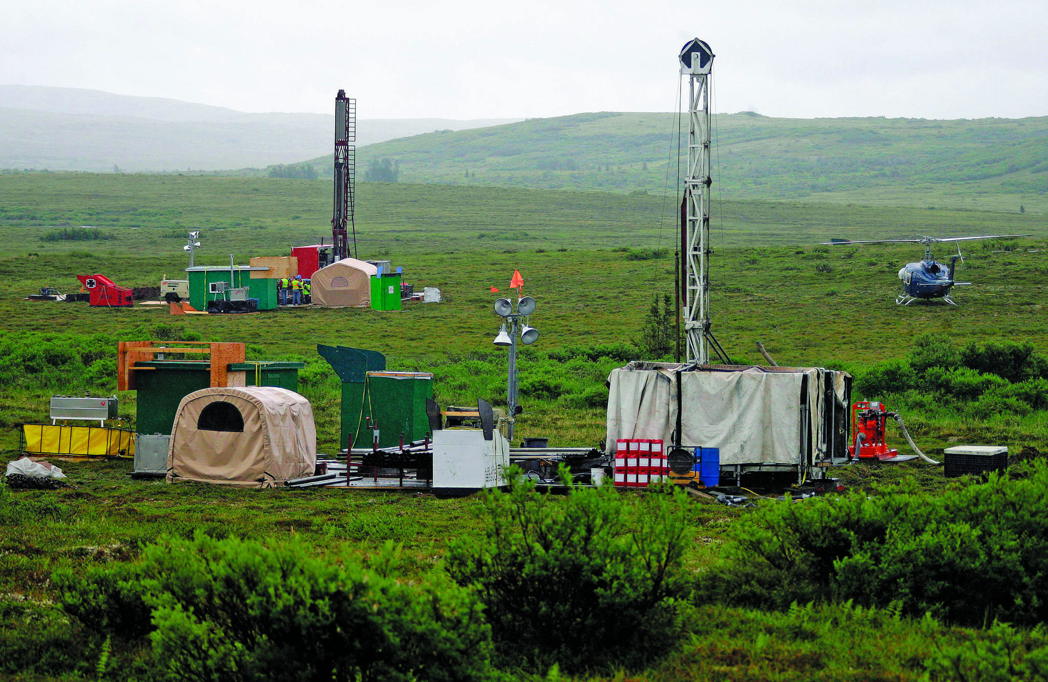 In this July 2007, photo, workers with the Pebble Mine project test drill in the Bristol Bay region of Alaska, near the village of Iliamma. The Pebble Limited Partnership, which wants to build a copper and gold mine near the headwaters of a major U.S. salmon fishery in southwest Alaska, says it plans to offer residents in the region a dividend. (AP Photo | Al Grillo, File)